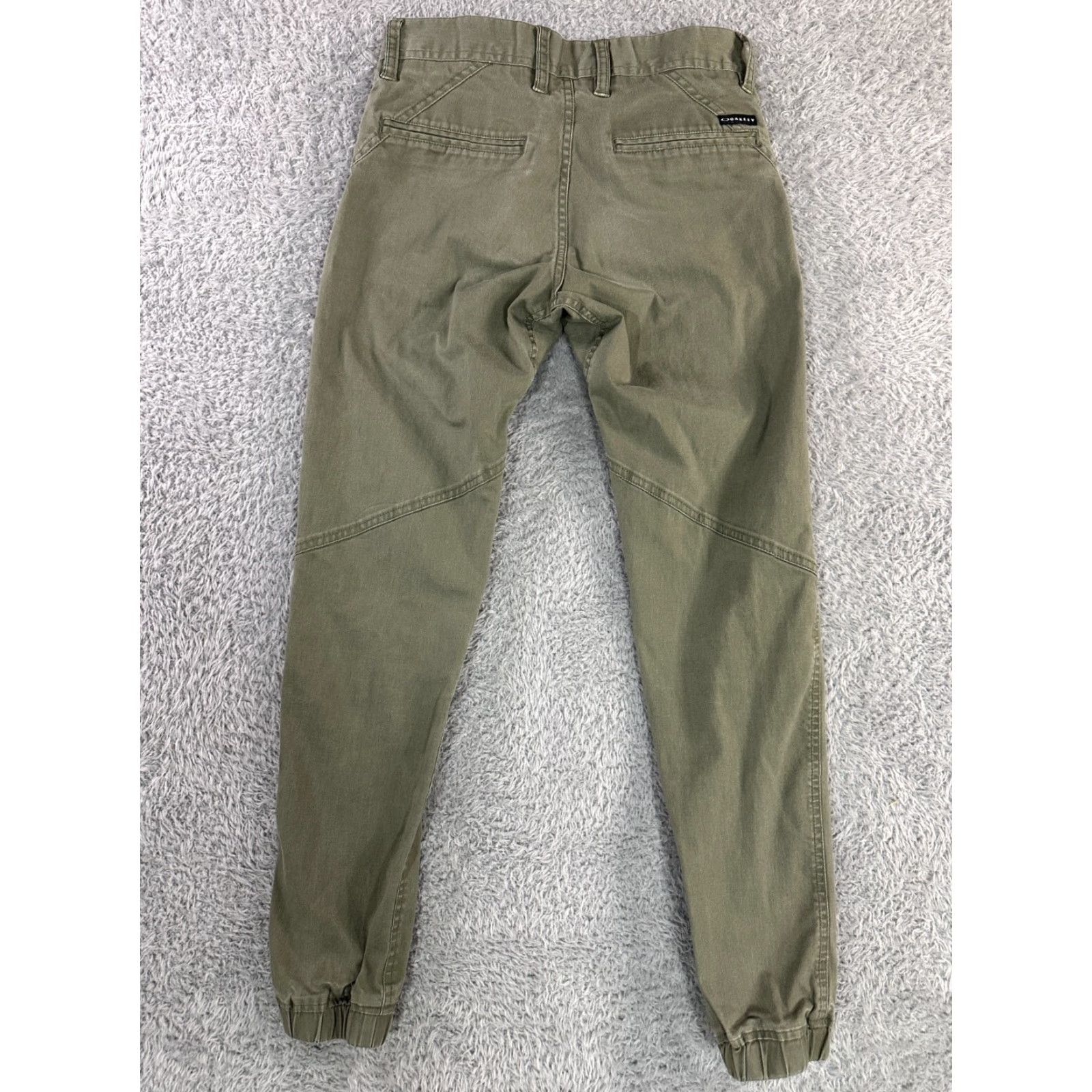 Oakley Oakley Pants Mens Olive Green Stretch Tapered Elastic Cuffs Size 28 Front Flat Front Zipper Logo Belt Loops 60/36/4 Elastane Casual Pants Size US 28 / EU 44 - 2 Thumbnail