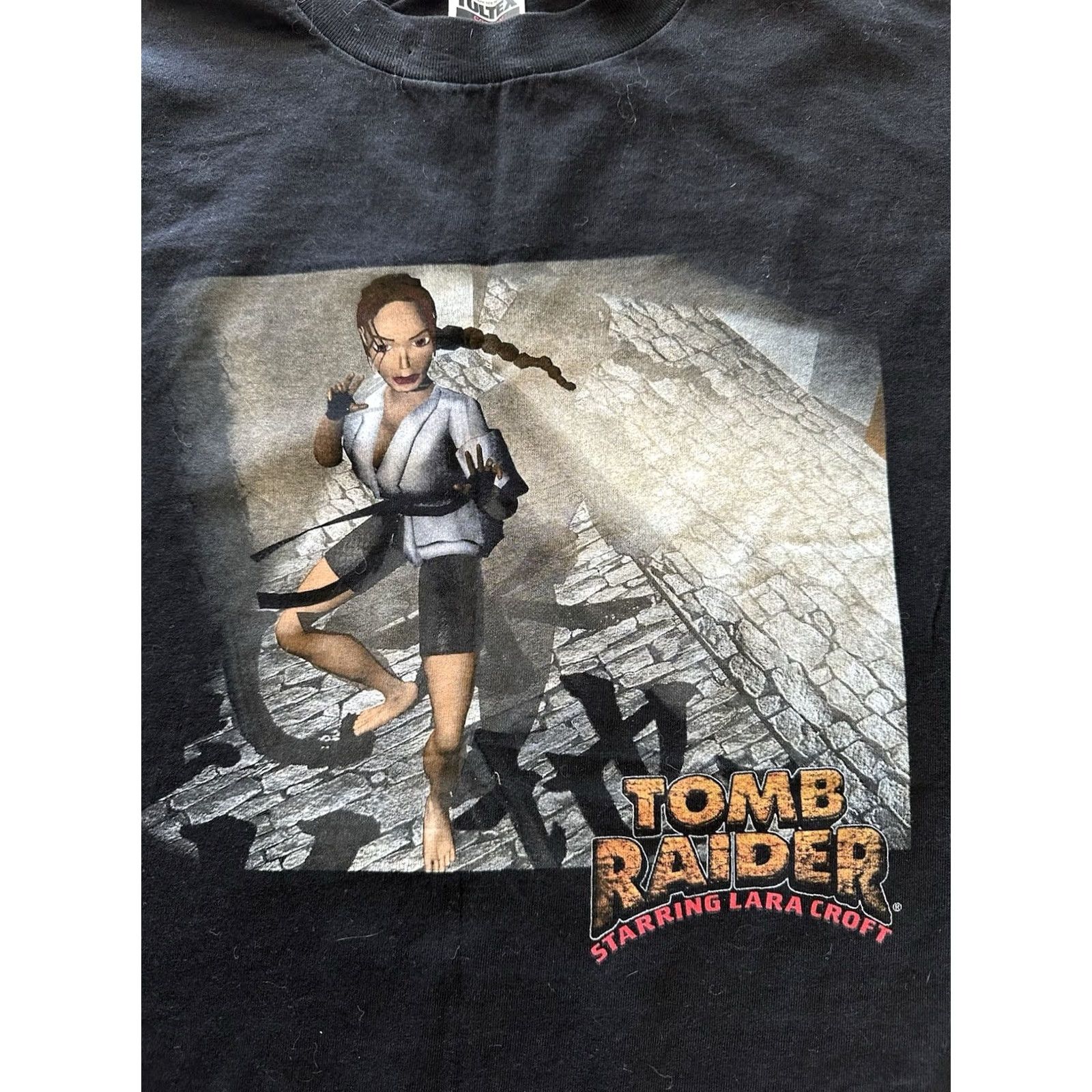 Tultex VINTAGE 90S LARA CROFT TOMB RAIDER VIDEO GAME KARATE PROMO T SHIRT XL NWOT Tultex Black Short Sleeve Cotton Graphics Mens Size US XL / EU 56 / 4 - 2 Thumbnail