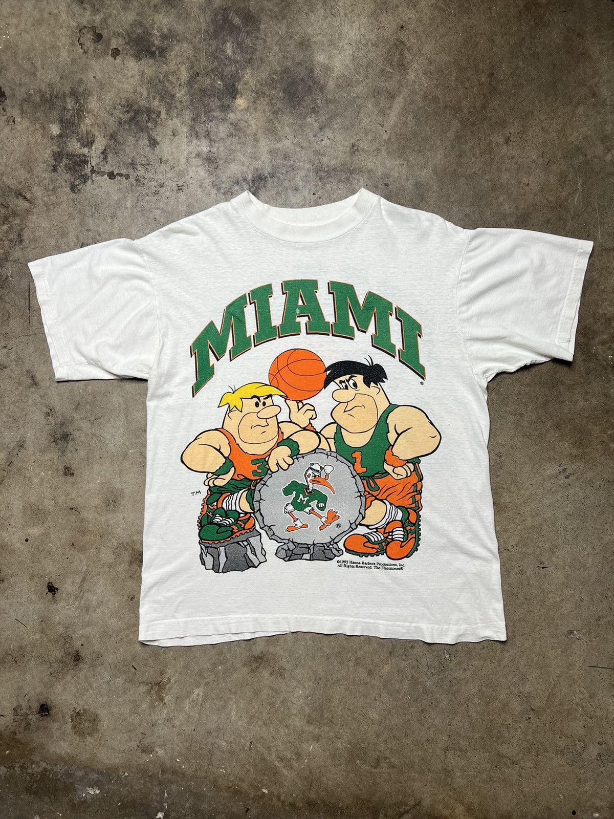 image of Cartoon Network x Disney Vintage Flintstones Miami Hurricane Football Cartoon Shirt in White (Size 