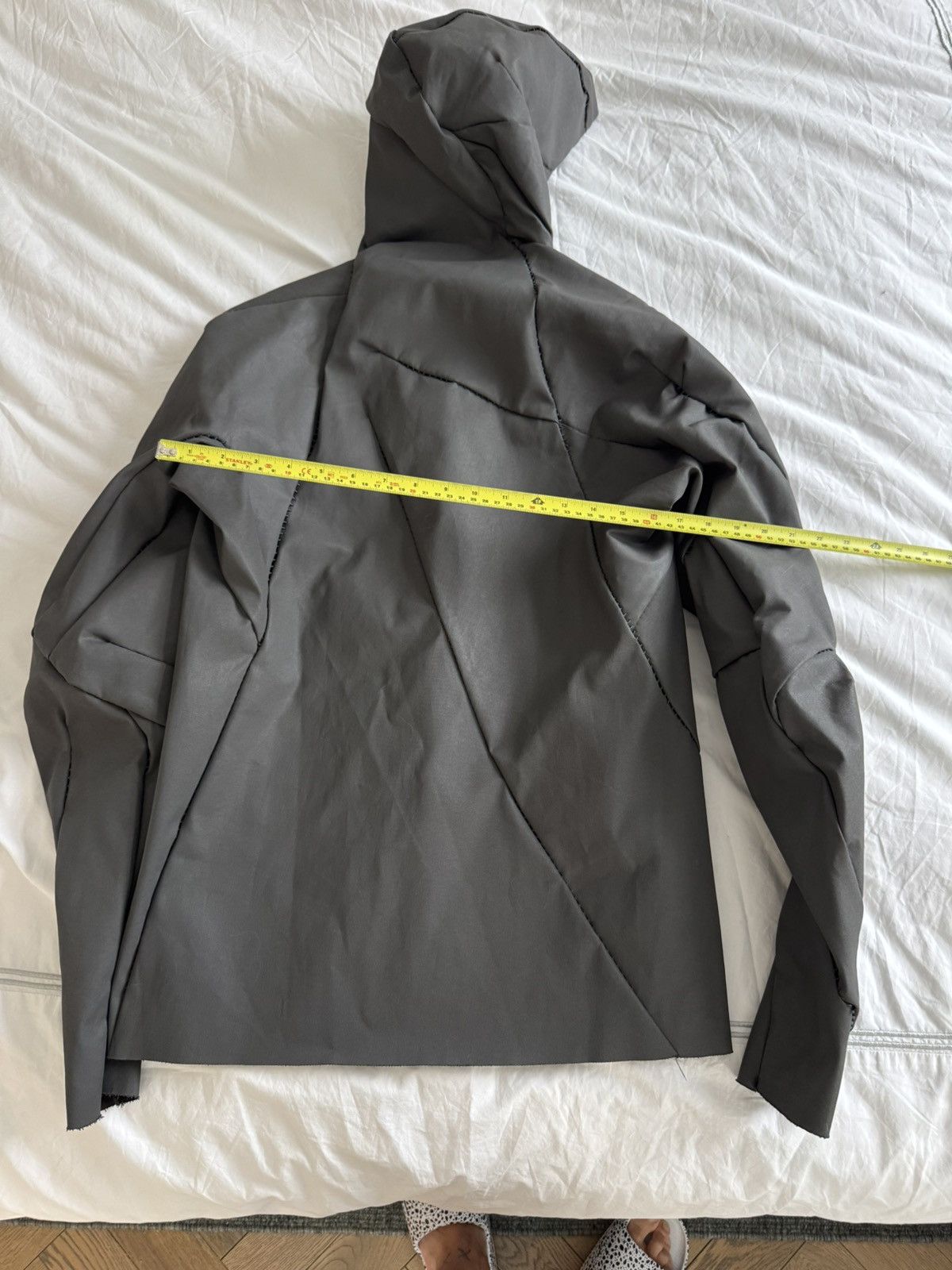Unlined hand stitched hooded jacket.