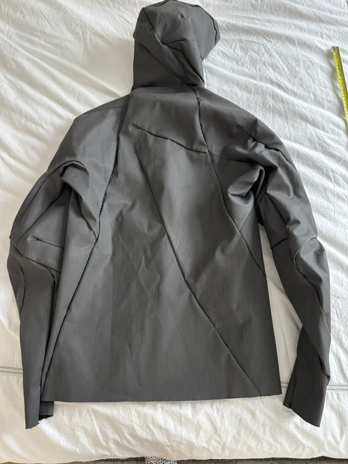 Unlined hand stitched hooded jacket.