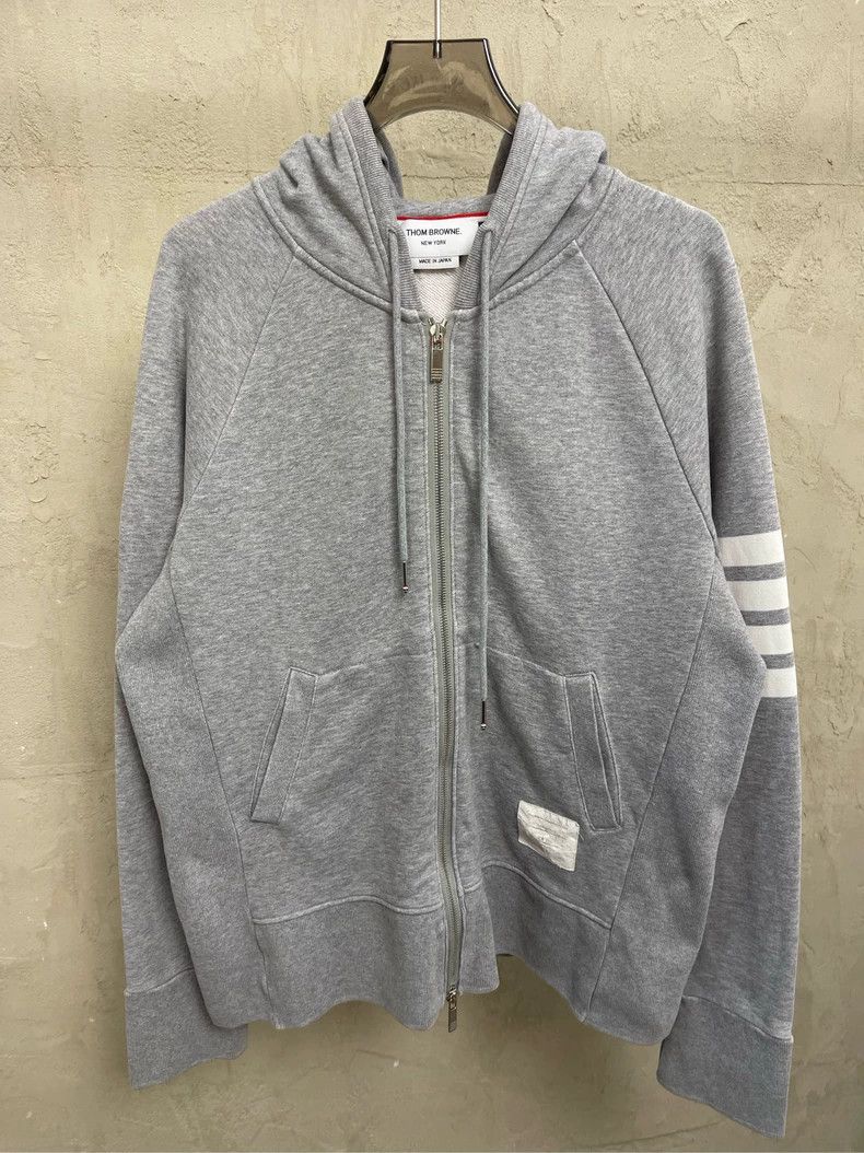 Thom Browne A trench coat with a hood