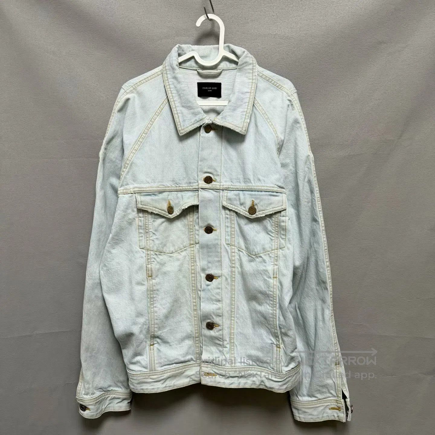 fear of god denim jacket with gold accents.