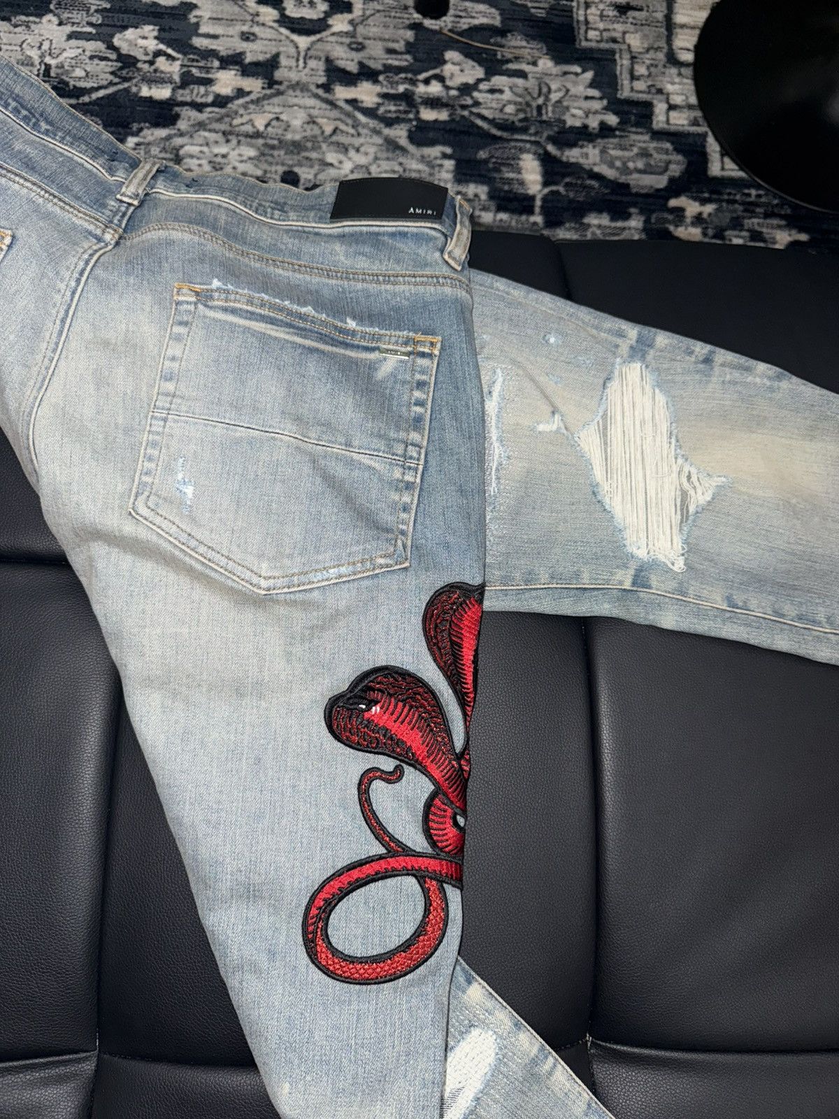 Amiri snake appliqué jeans