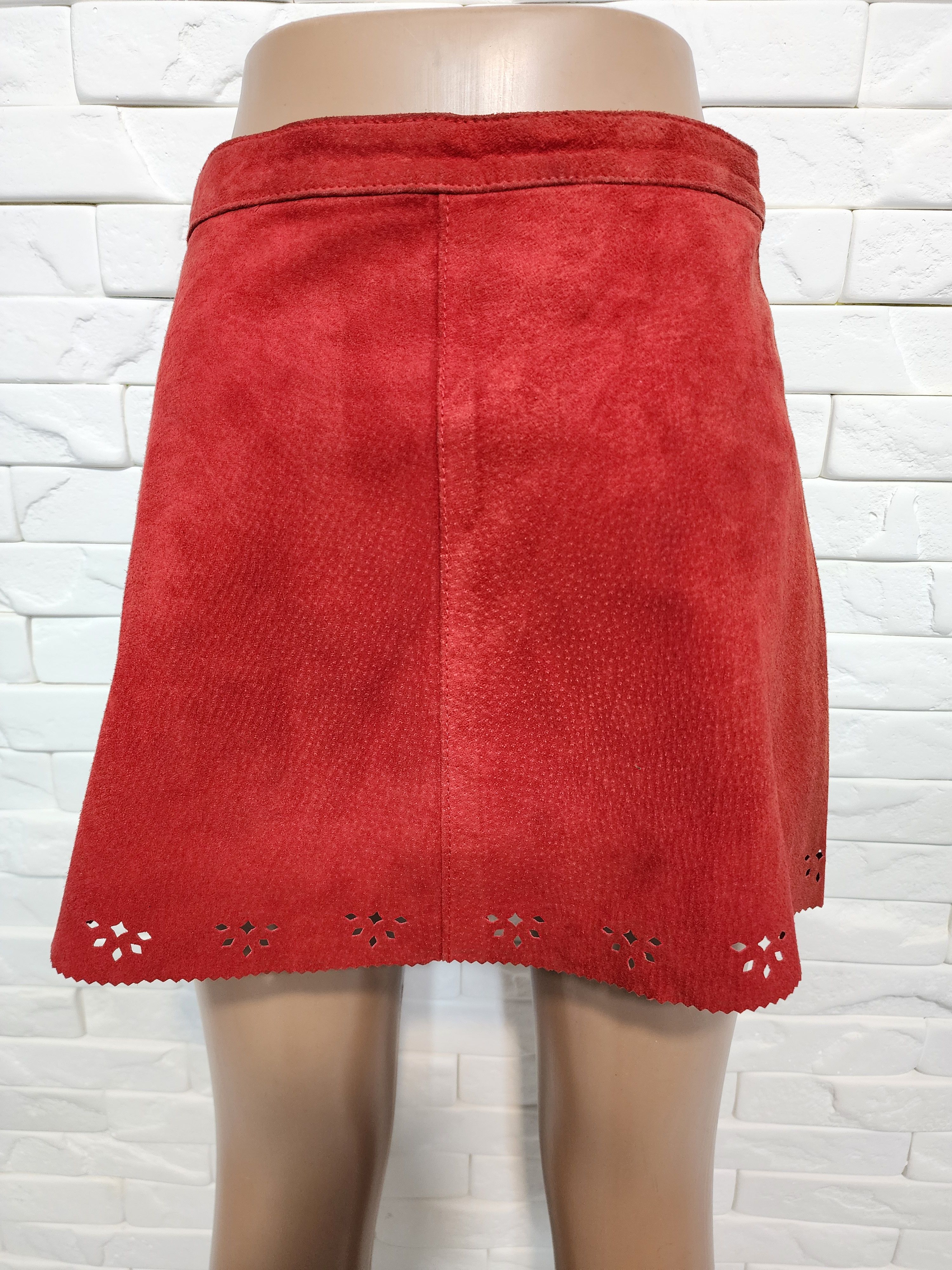 Red skirt made of genuine suede with perforation.