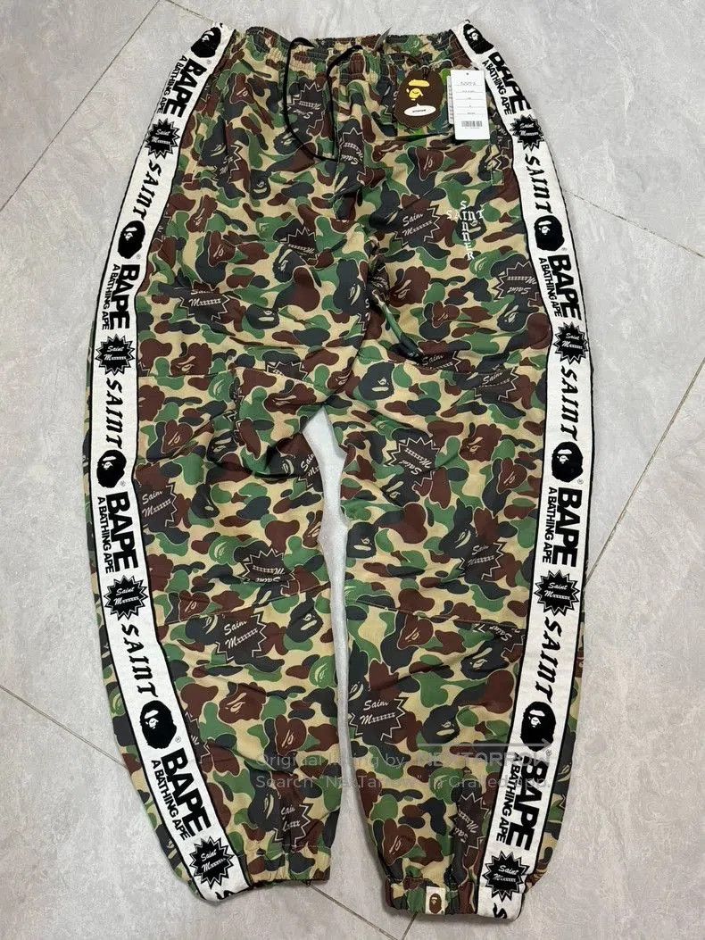 SAINT Mxxxxxx x BAPE Camo Track Pants.