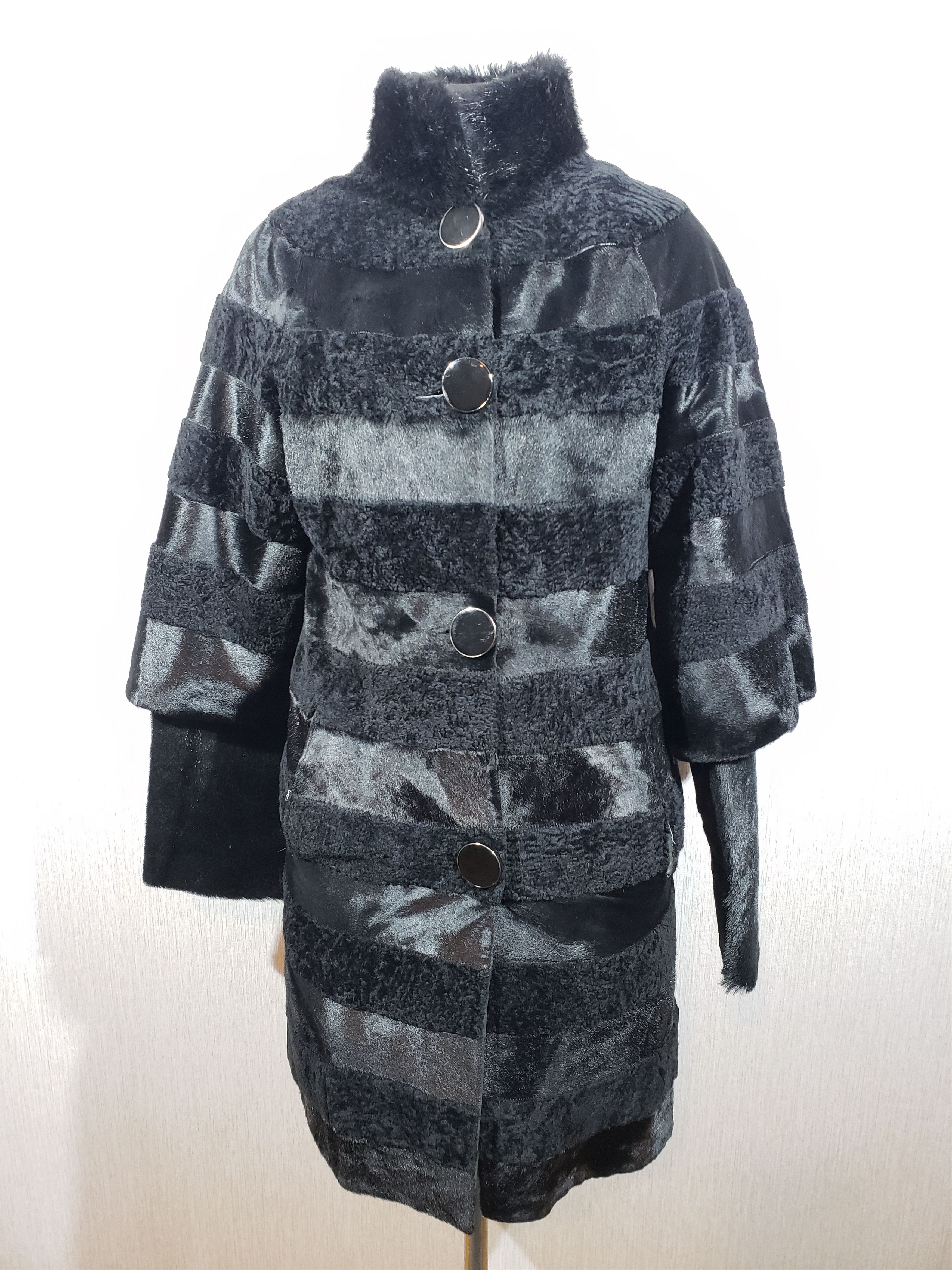 Combined fur coat made of black sheepskin and smooth fur.