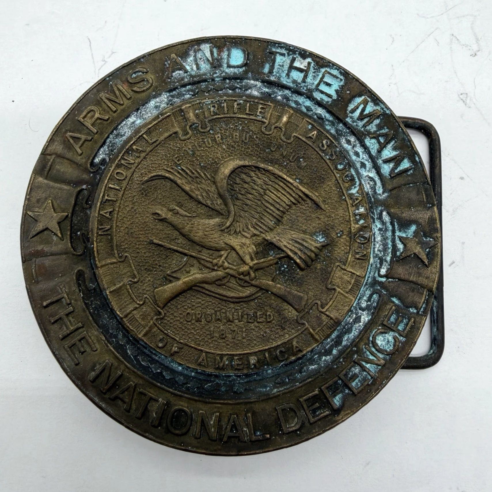 Vintage VINTAGE ARMS AND THE MAN THE NATIONAL DEFENCE Wyoming Round Brass Belt Buckle Mens Bronze 1970s Flag Theme Size ONE SIZE - 2 Thumbnail