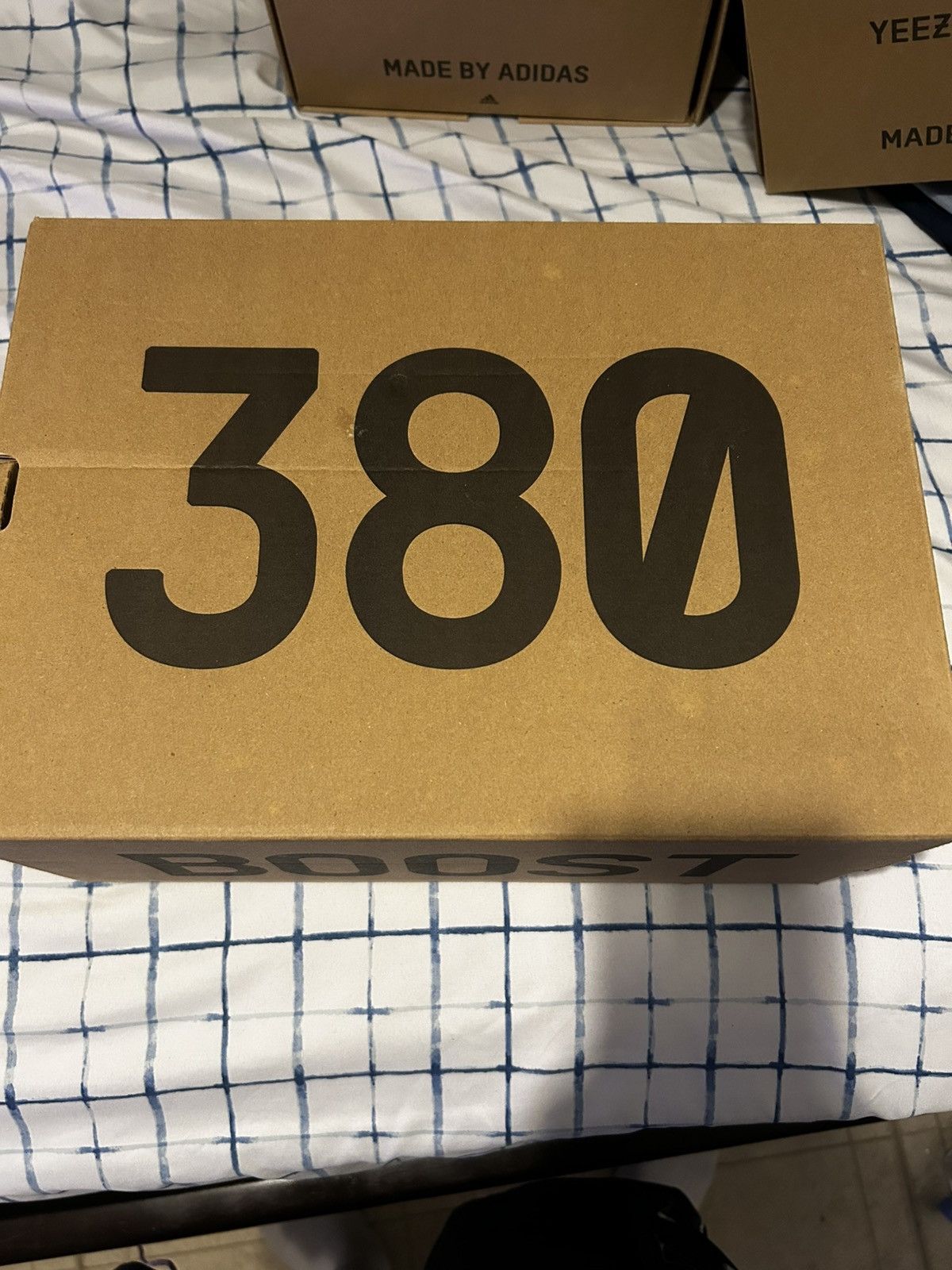 Brown and black Yeezy Boost 380 trainers