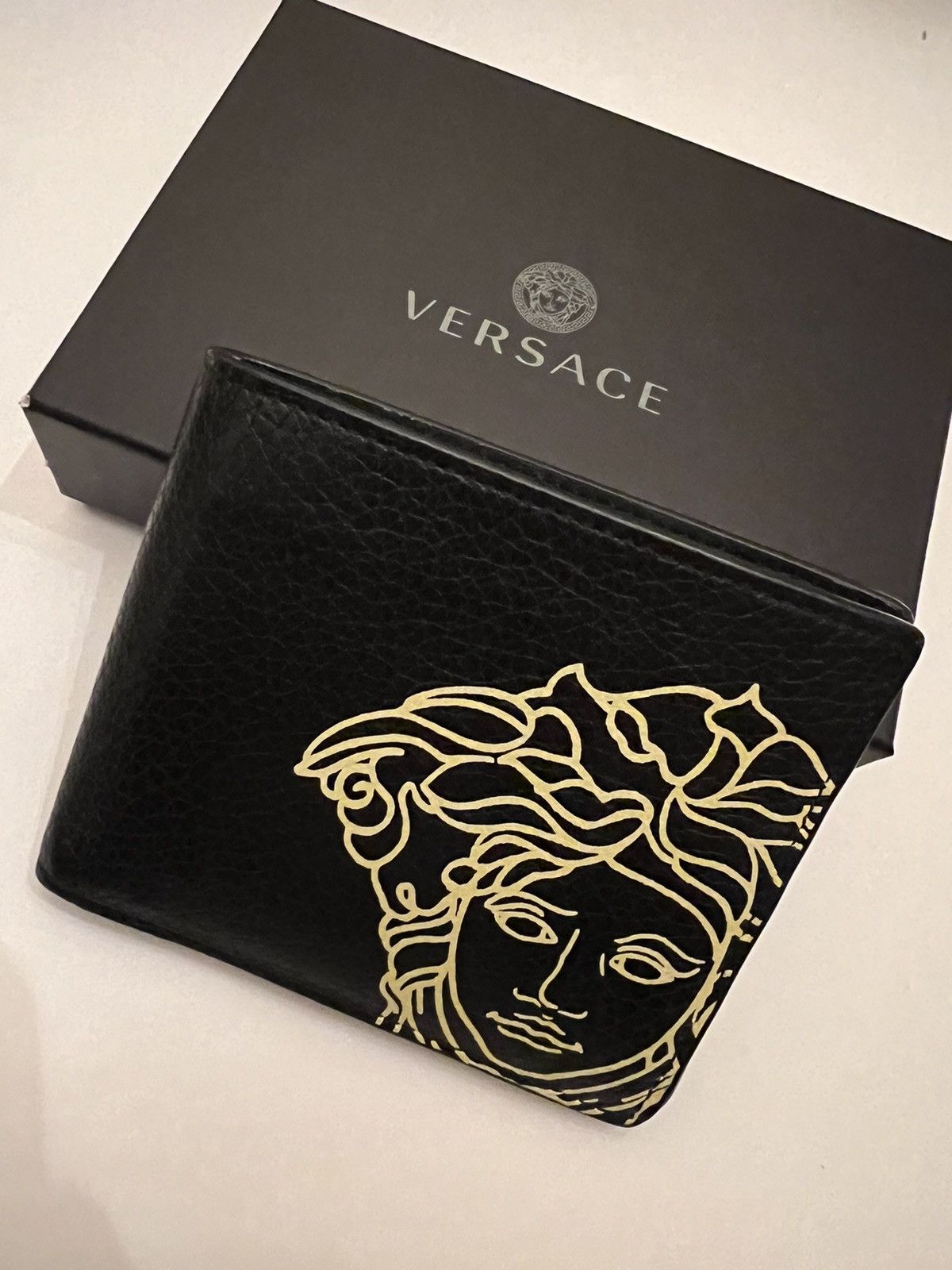 image of Versace Medusa Print Grained Leather Bifold in Black, Men's