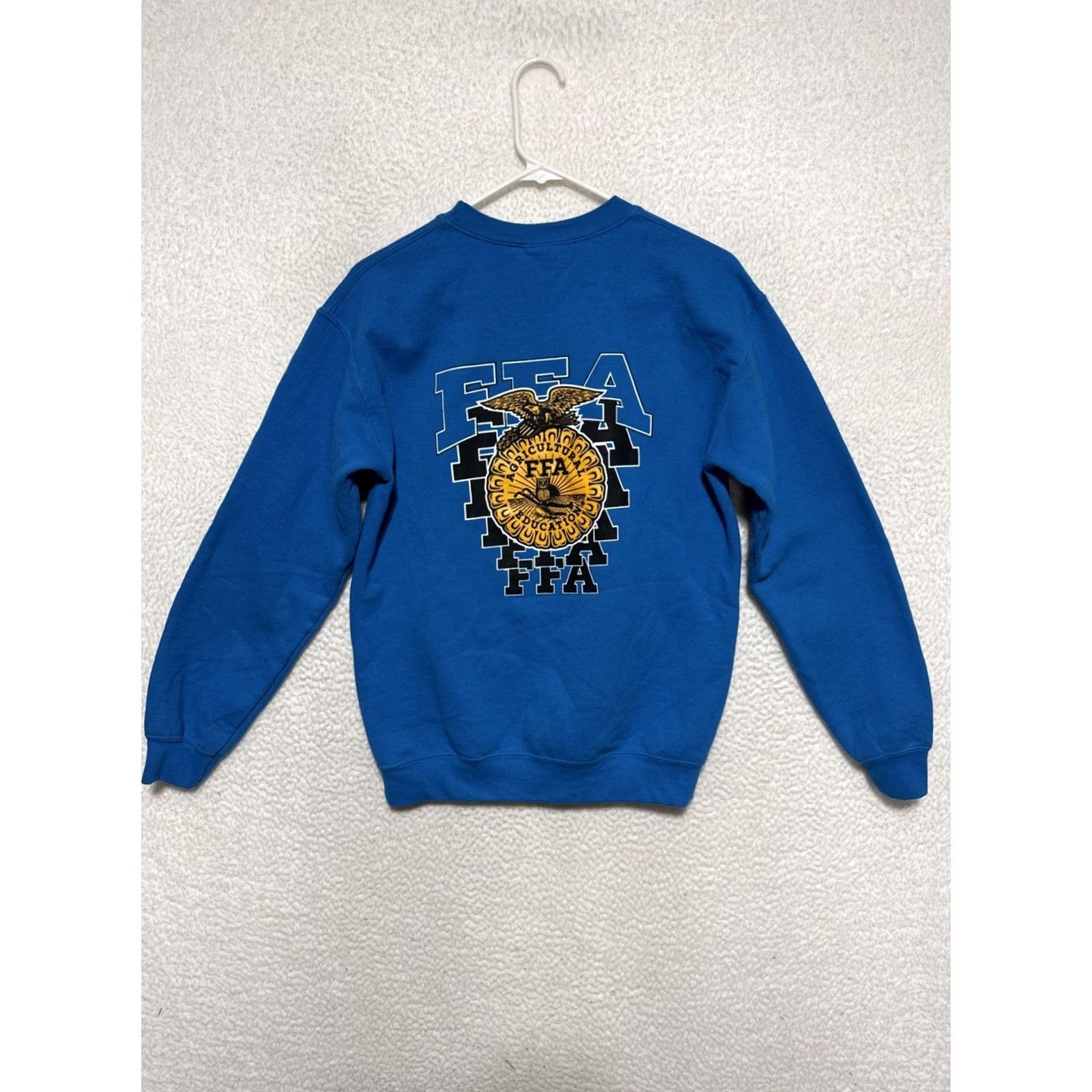Gildan 2. It leverages key words (Gildan, FFA Agri Ed., Alma, MI, Crewneck, Sweatshirt, Blue, Small) Size US S / EU 44-46 / 1 - 3 Thumbnail