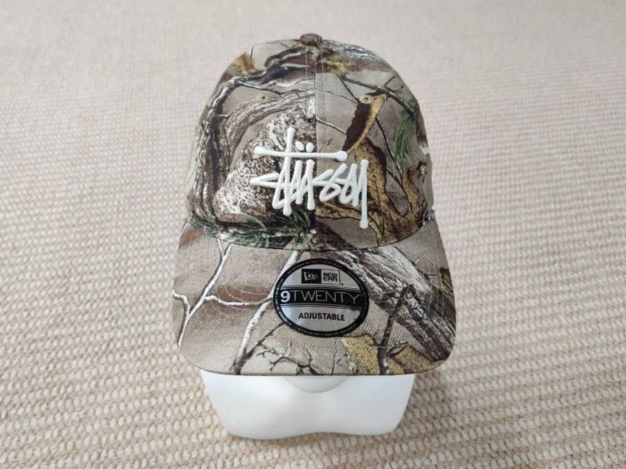 STUSSY REAL TREE EDGE CAMO NEW ERA 9TWENTY BASIC TRUCKER HAT