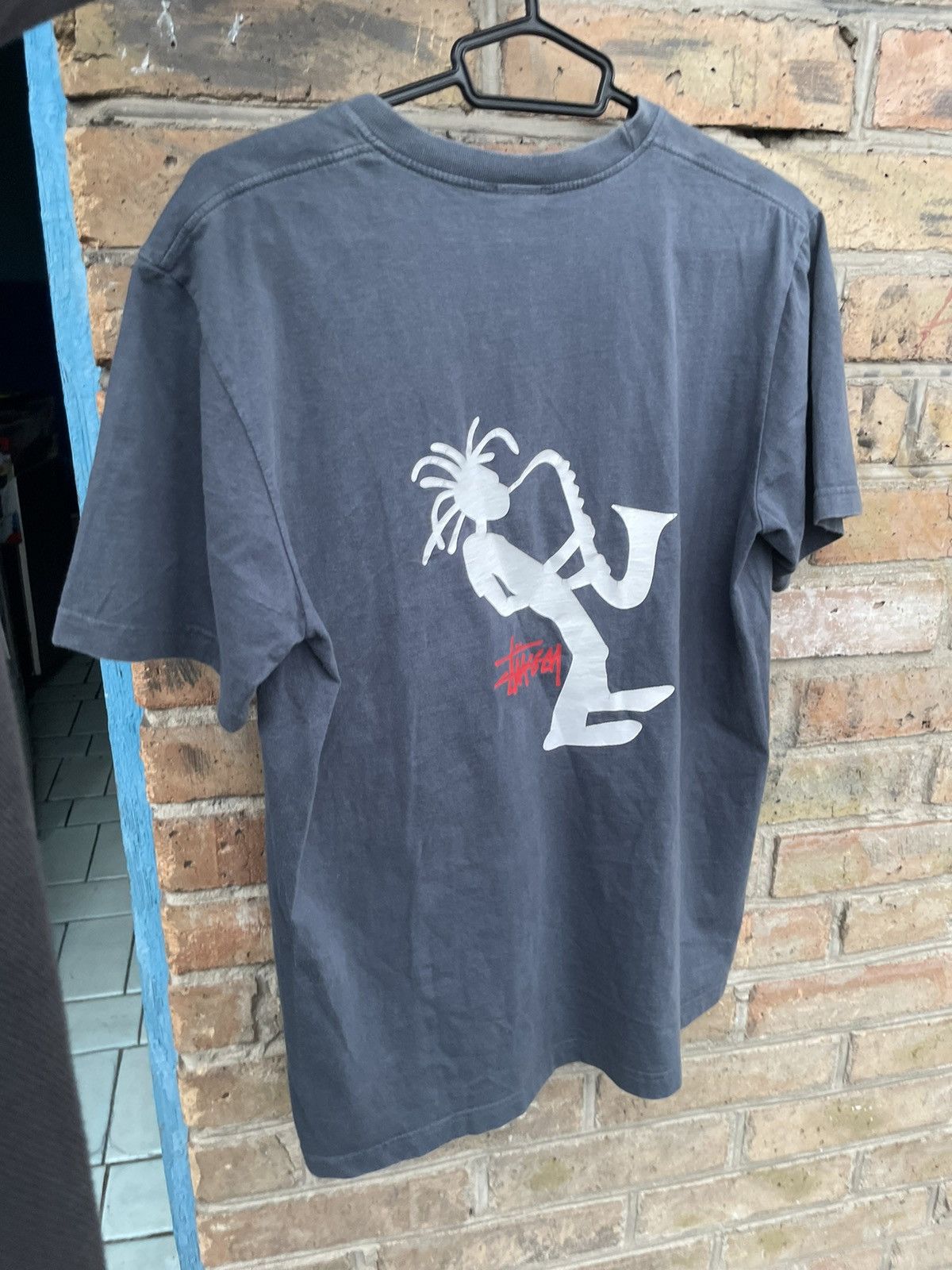 image of 80's Stussy Outdoor T-Shirt Jazz Man in Faded Blue, Men's (Size Large)