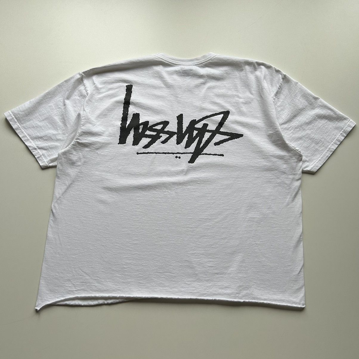 image of Vintage Stussy Upside Down Logo Graphic T Shirt Cropped in White, Men's (Size 2XL)