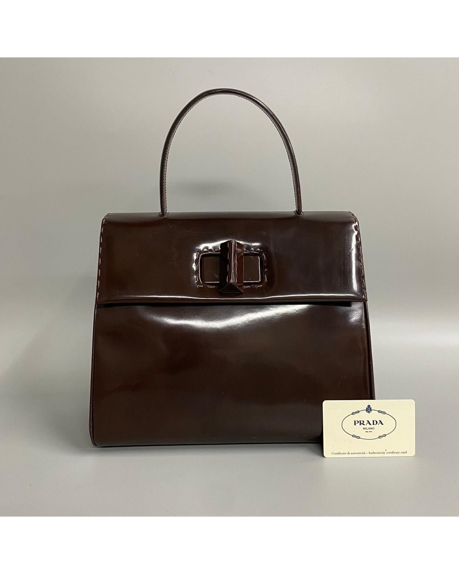 image of Prada Patent Leather Top Handle Bag With Turnlock Closure in Brown, Women's
