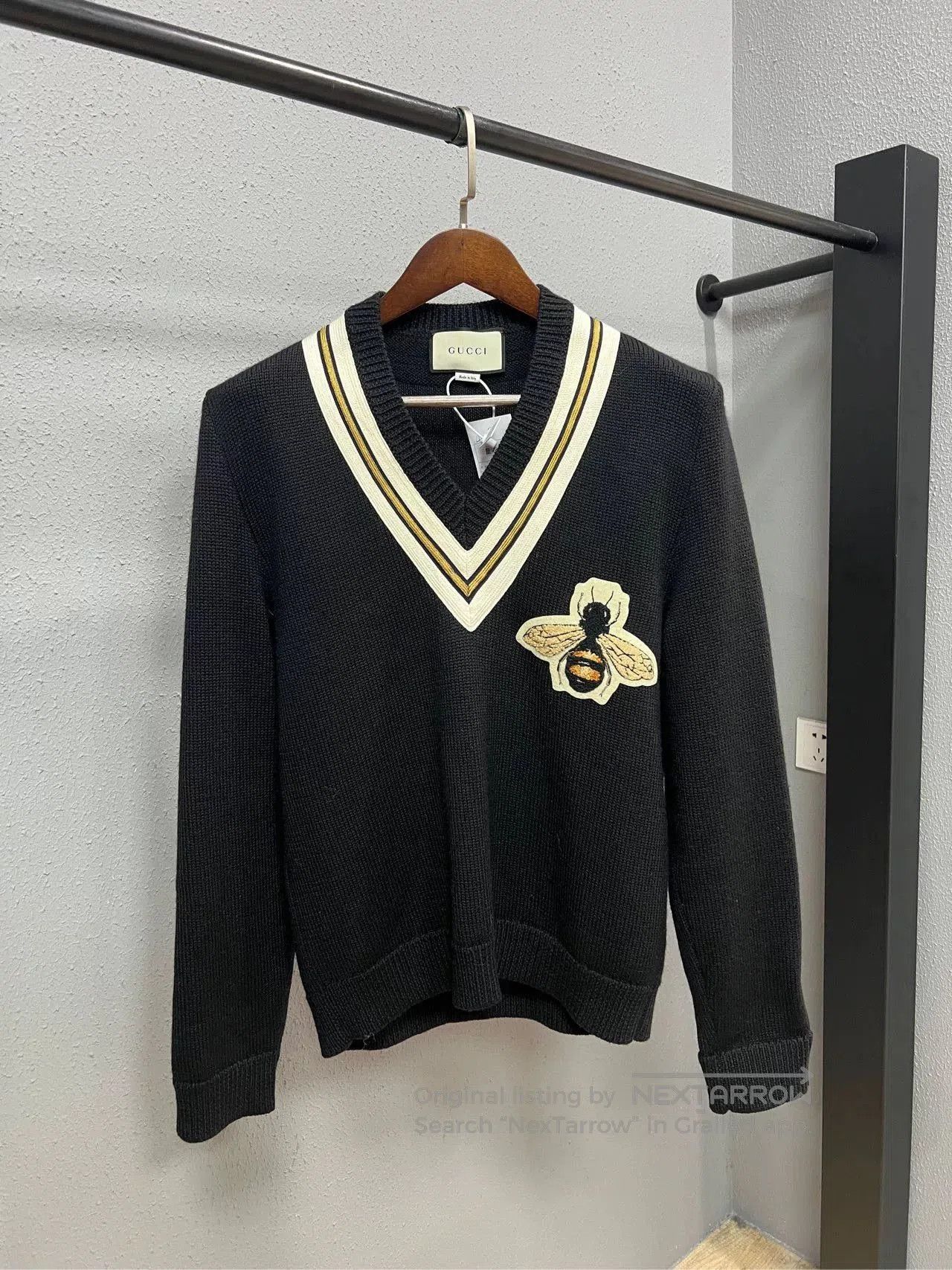 gucci black sweater with bee motif.