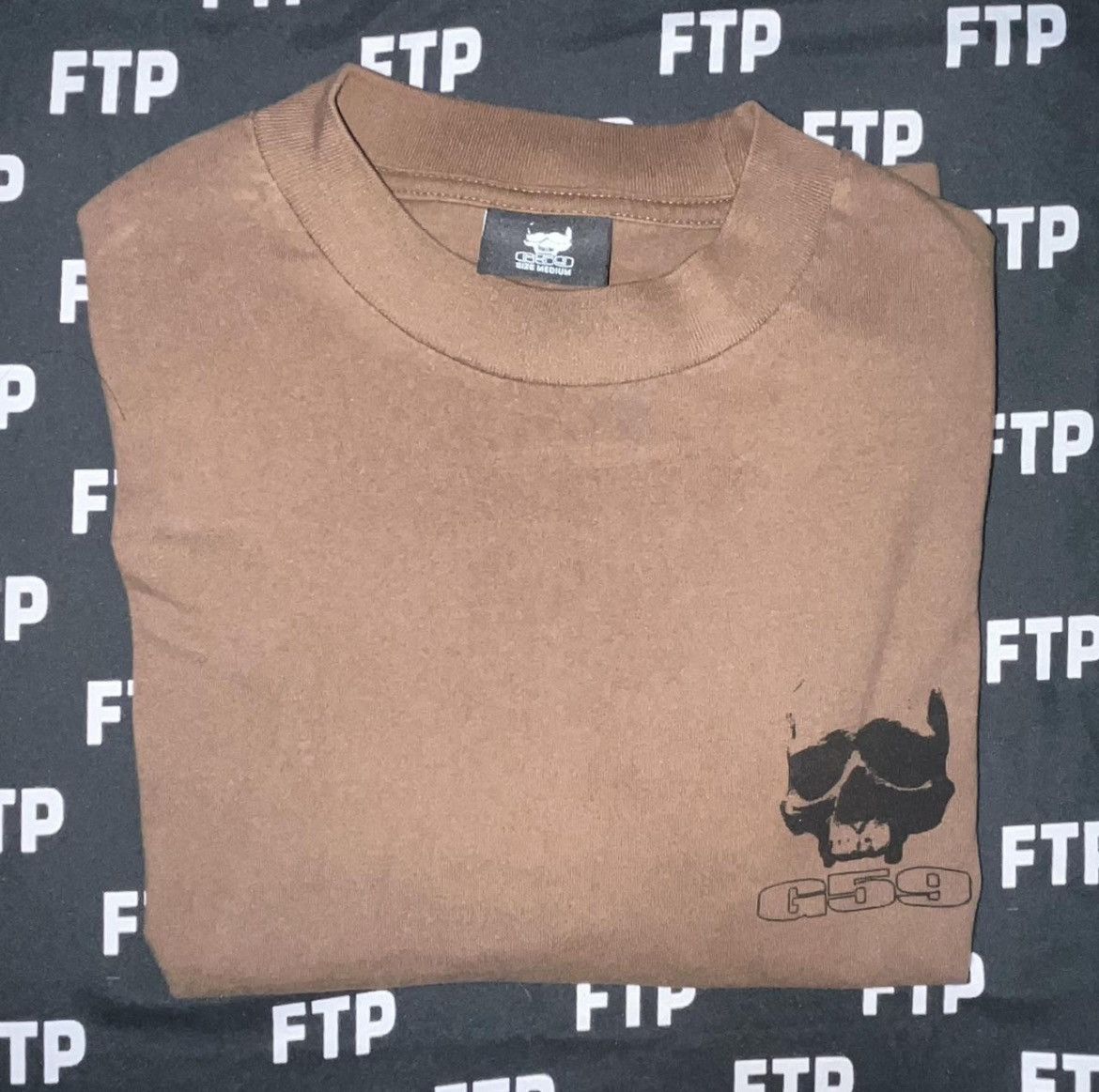 G59 Records G59 LOGO TEE (BROWN) Size US M / EU 48-50 / 2 - 1 Thumbnail