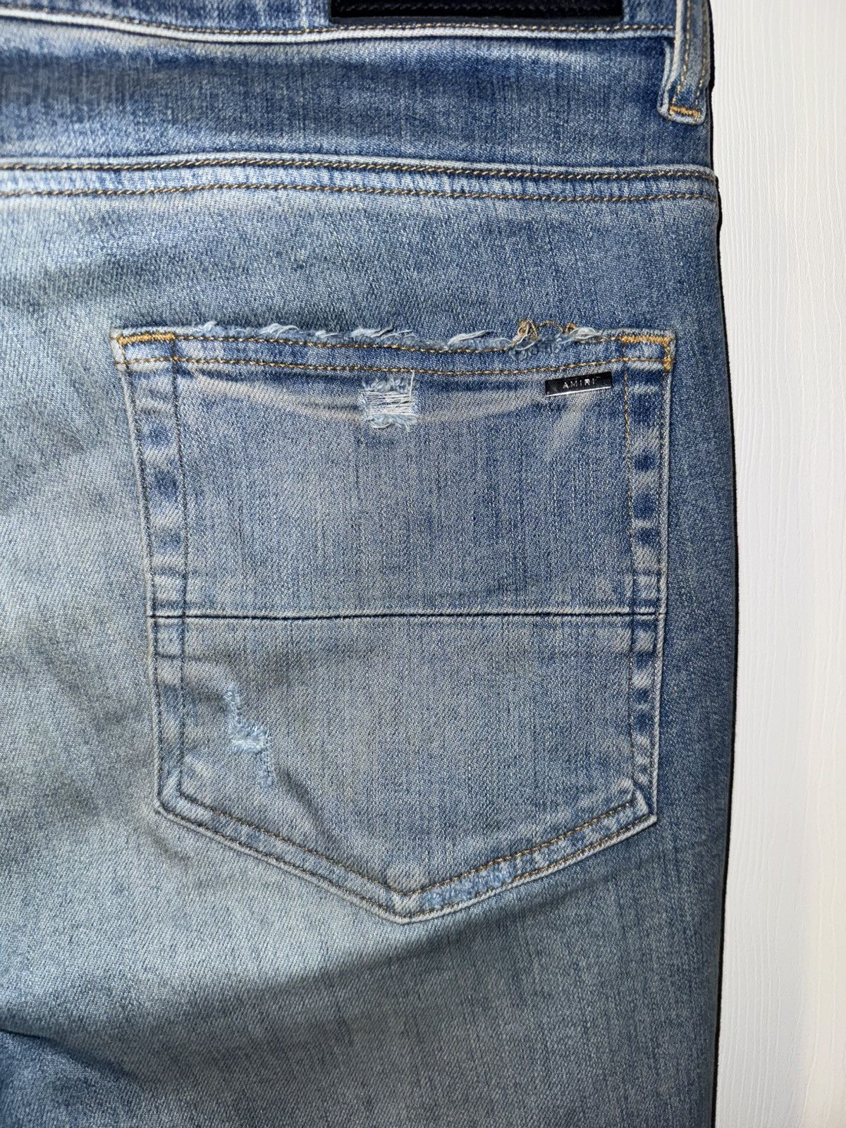 AMIRI BLUE DISTRESSED JEANS
