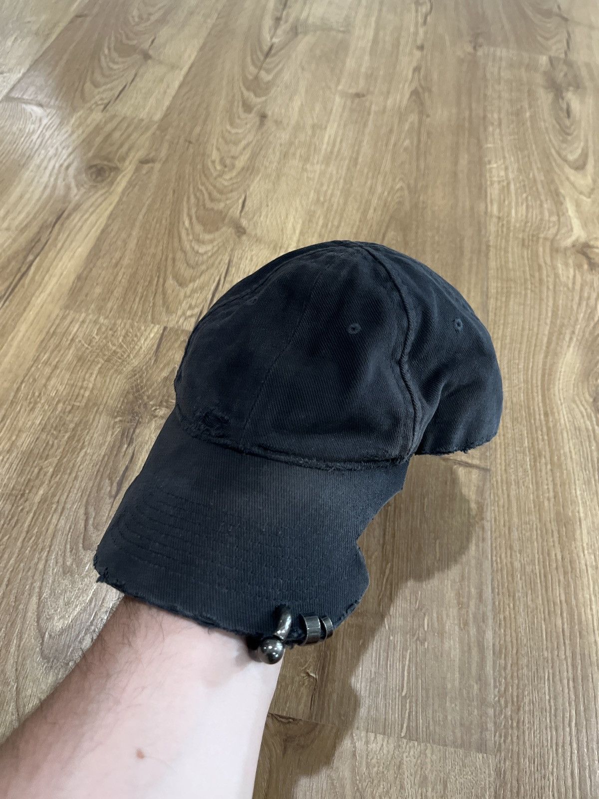 image of Balenciaga Mud Show Heavy Piercing Hat in Black, Men's