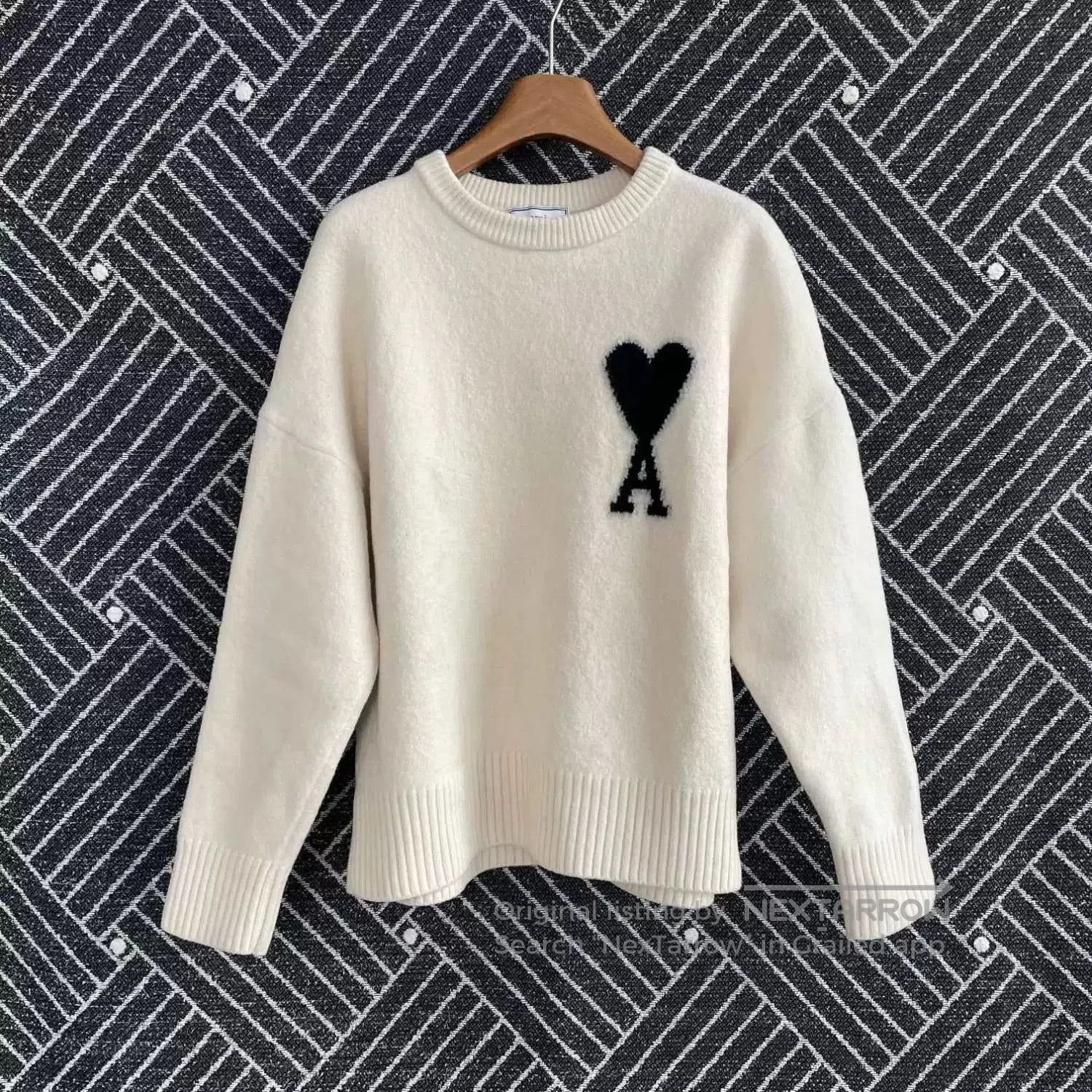 oversized cream sweater with heart logo.