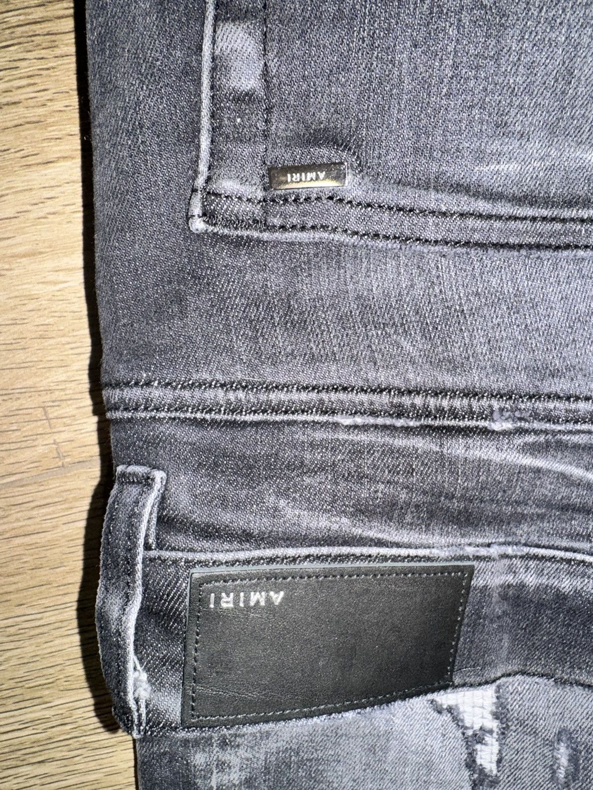 AMIRI logo-print ripped skinny jeans