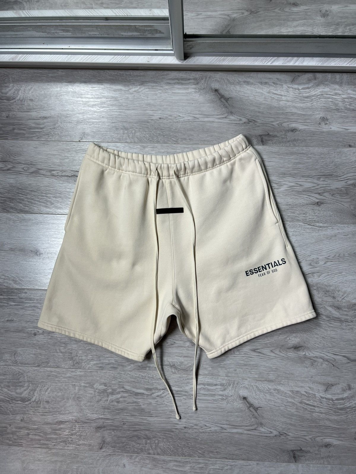 Fear of God FEAR OF GOD Essentials Reflective Logo Cream Shorts | Grailed