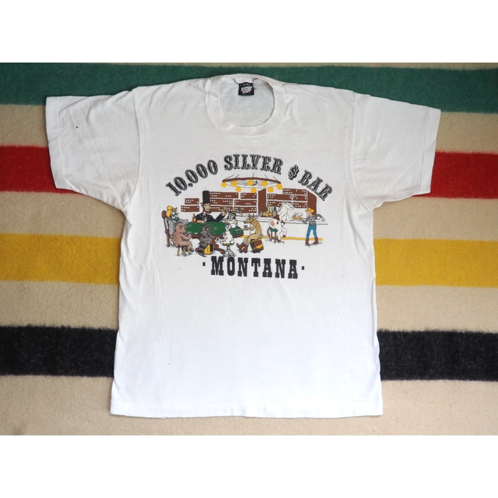 Vintage VTG 80s 90s Screen Stars Montana 10000 Silver Dollar Bar Art White Tee T-Shirt L Men Short Sleeve Cotton Blend Graphic Tee Size US L / EU 52-54 / 3 - 2 Thumbnail