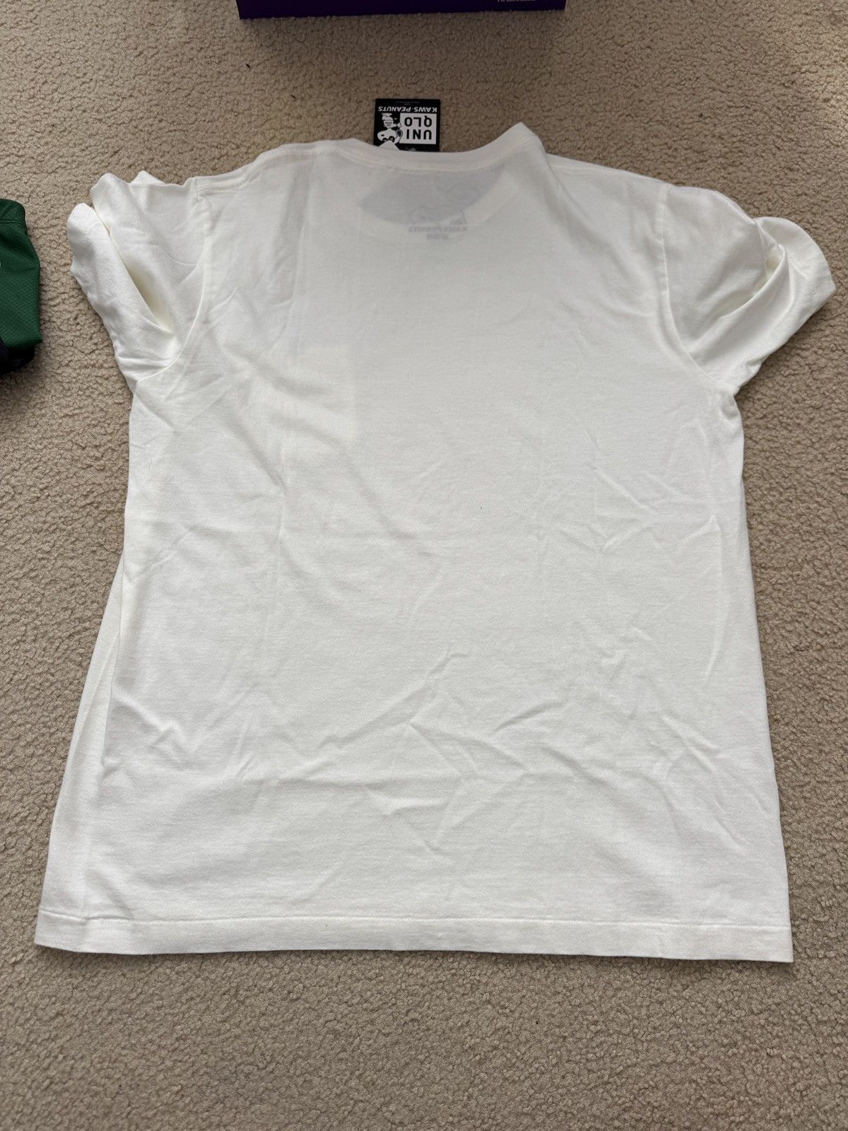 Kaws × Peanuts × Uniqlo Uniqlo x Kaws x Peanuts Snoopy Pocket Tee Size L new Size US L / EU 52-54 / 3 - 6 Thumbnail