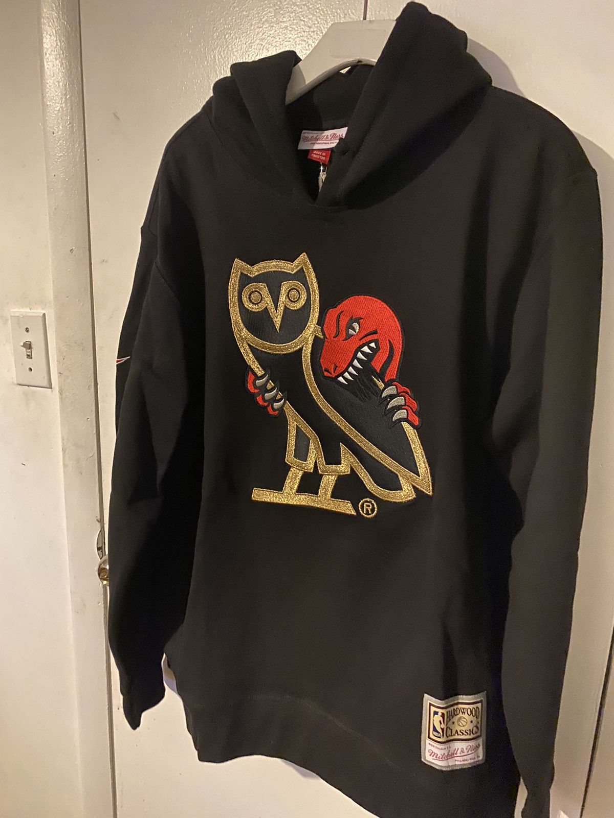 image of Mitchell Ness x Octobers Very Own Ovo X Mitchell & Ness OG Owl Raptors Hoodie in Black (Size 2XL)