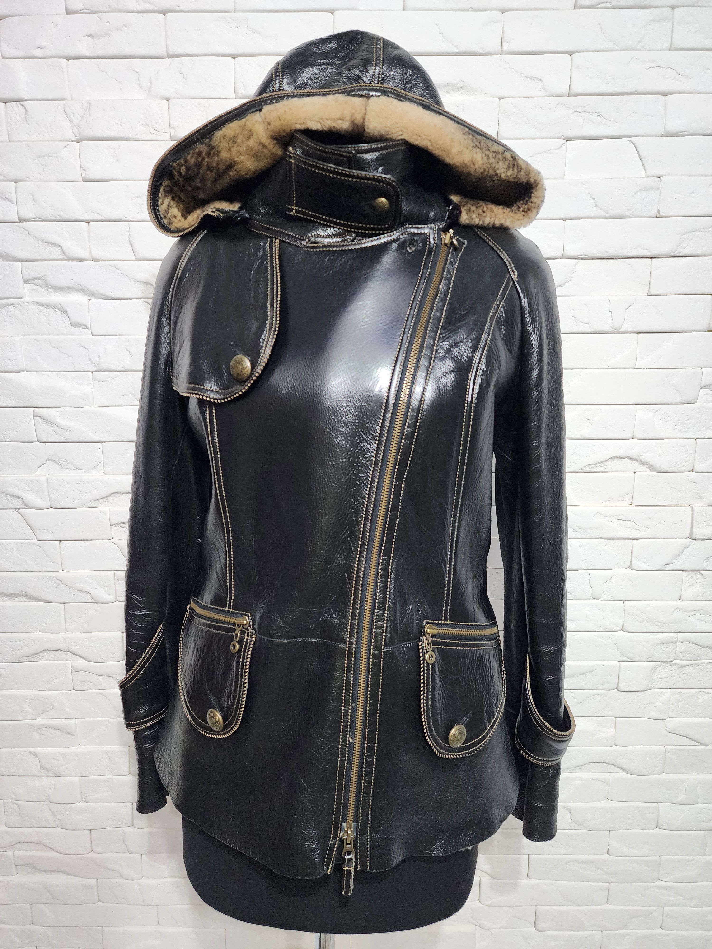 Black sheepskin coat with a metal zipper and hood.