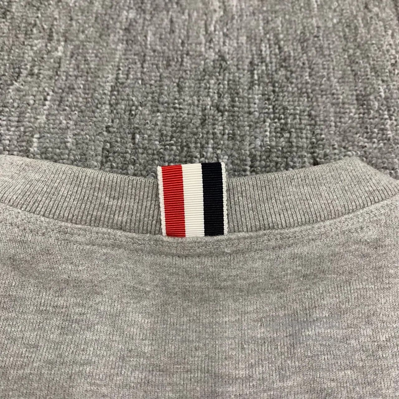 thom browne grey striped sweatshirt for men.