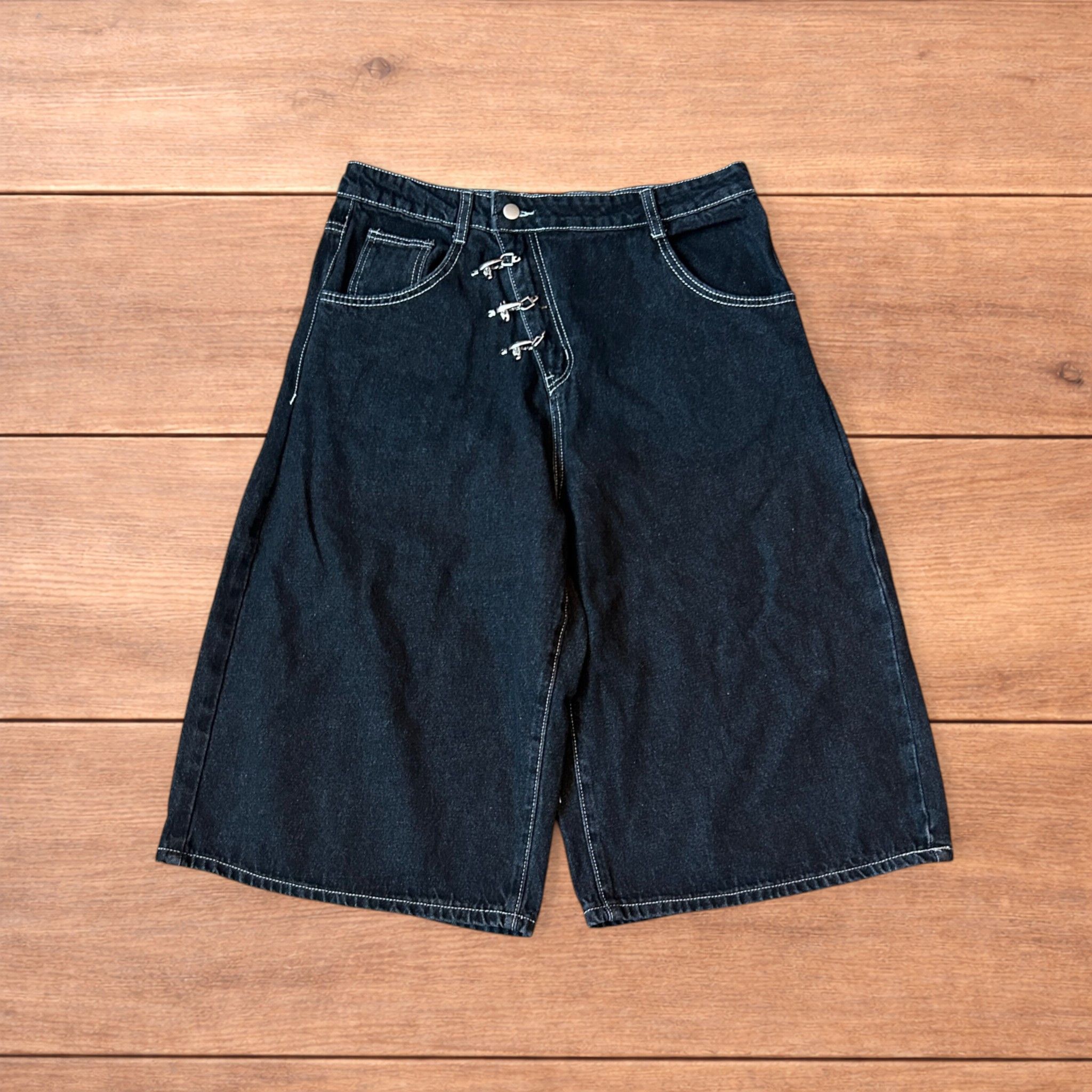 Baggy wide leg denim shorts jorts with buckles in black.