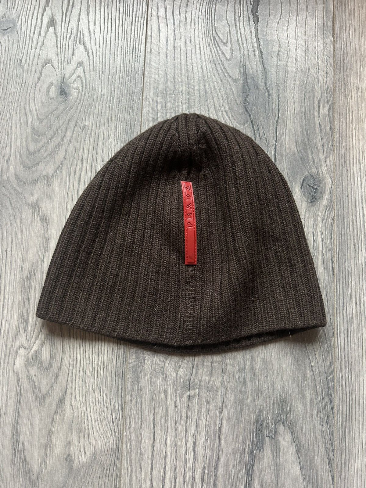 Pre-owned Prada Ribbed Knit Beanie With Red Logo Tab In Brown