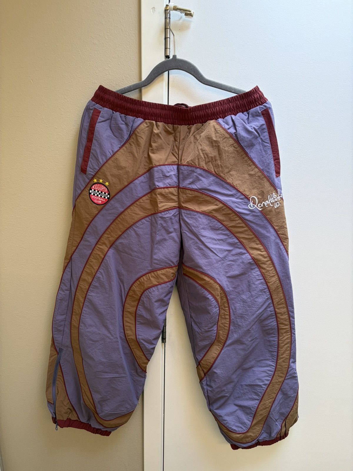 KidSuper RONALDINHO X KIDSUPER WINDBREAKER PANTS [BROWN / BLUE / RED] Size US 31 - 1 Thumbnail