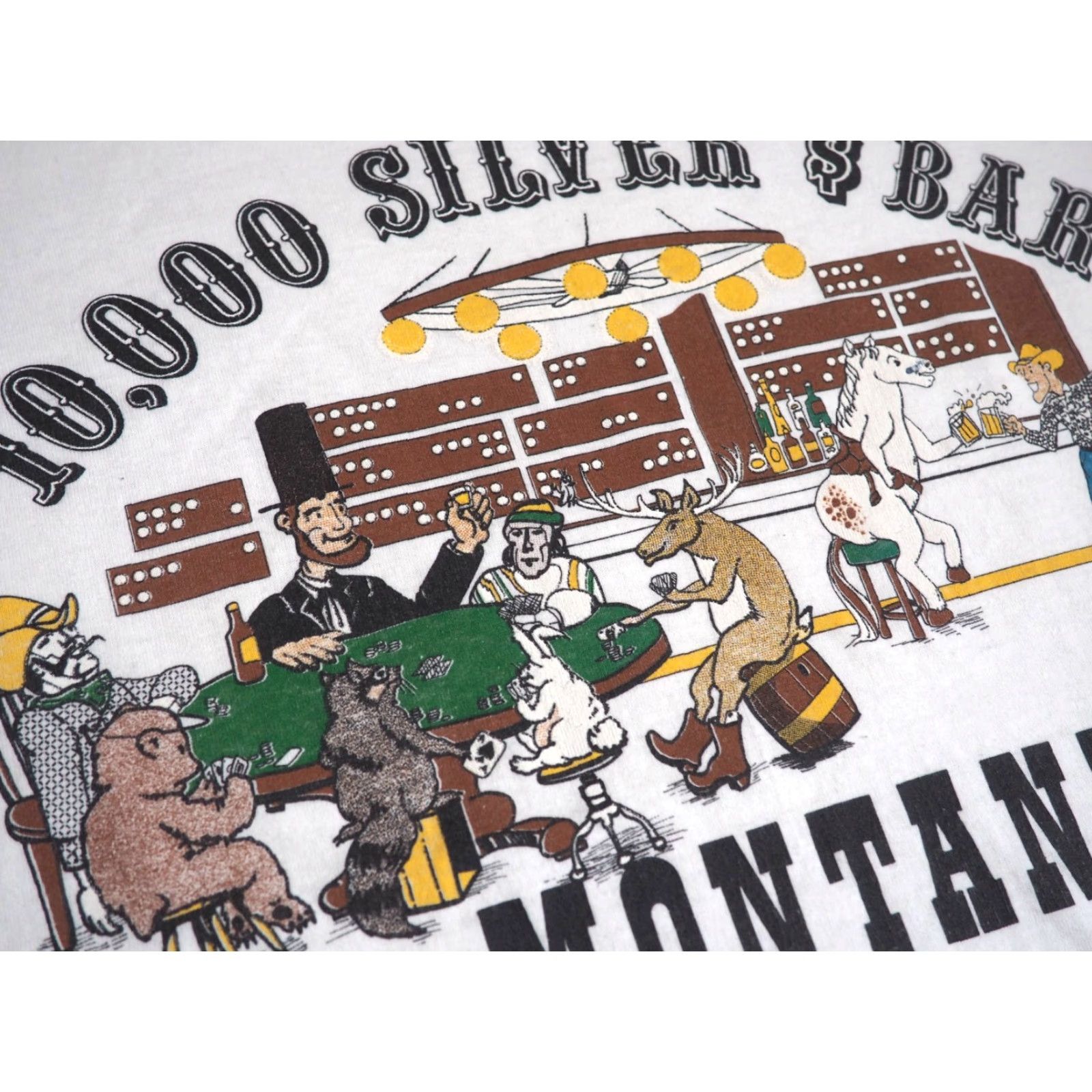 Vintage VTG 80s 90s Screen Stars Montana 10000 Silver Dollar Bar Art White Tee T-Shirt L Men Short Sleeve Cotton Blend Graphic Tee Size US L / EU 52-54 / 3 - 6 Thumbnail