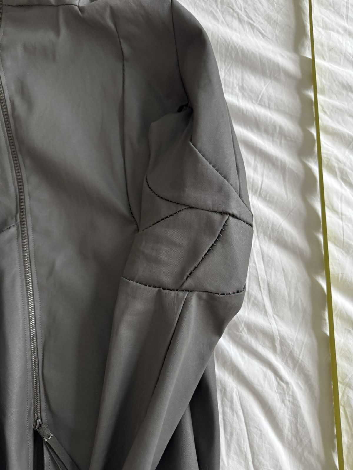 Unlined hand stitched hooded jacket.