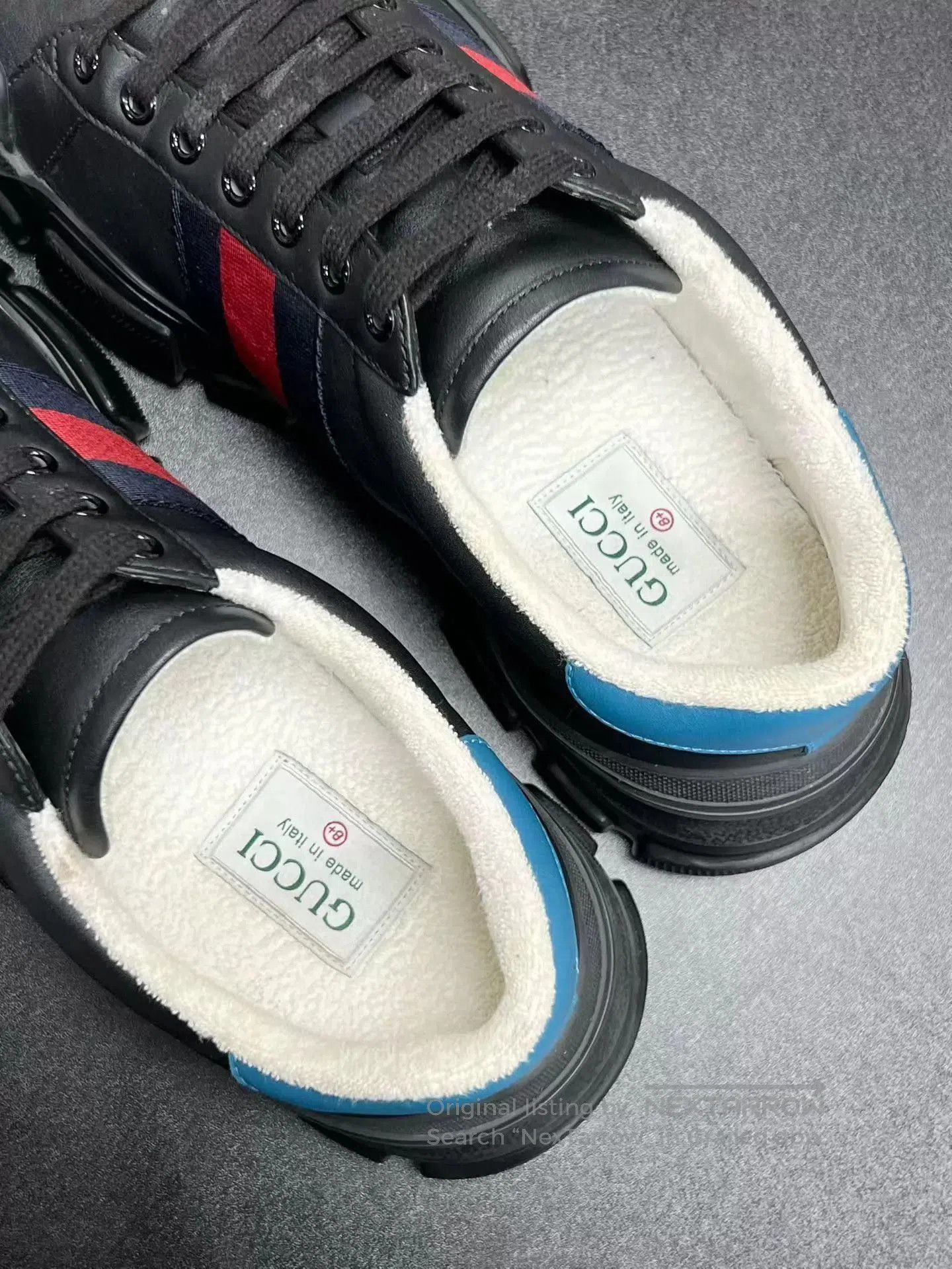 Black Low-Top Sneakers with Red and Blue Stripes.
