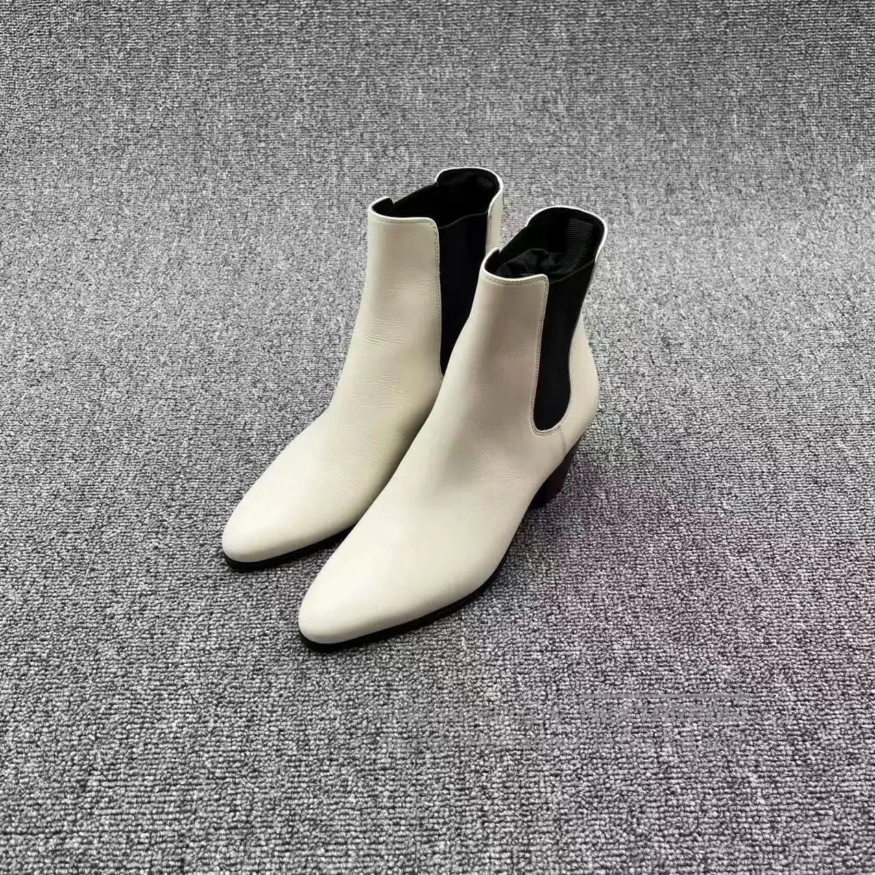 white leather pointed toe chelsea boots.