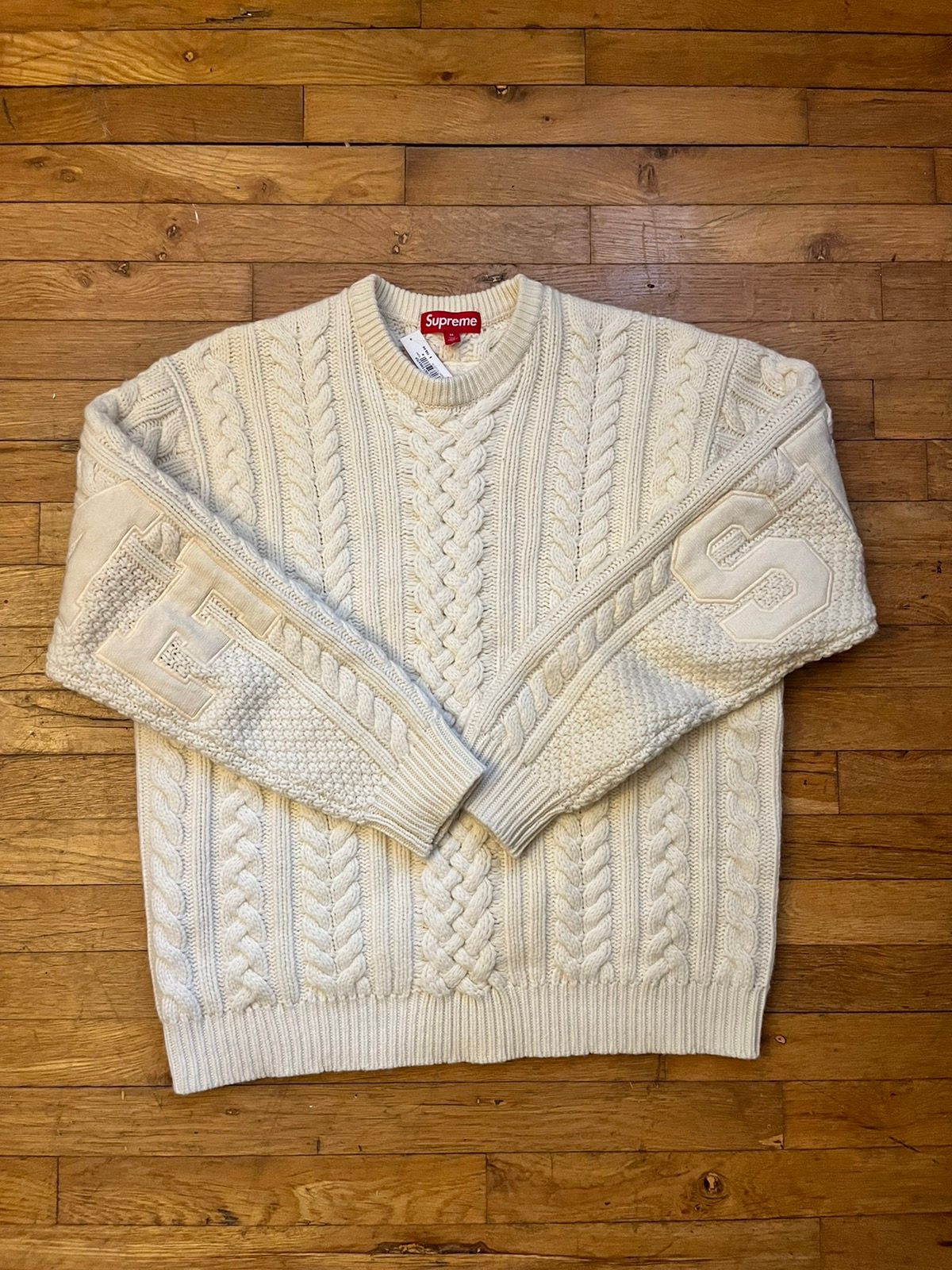 supreme appliqué cable knit sweater
