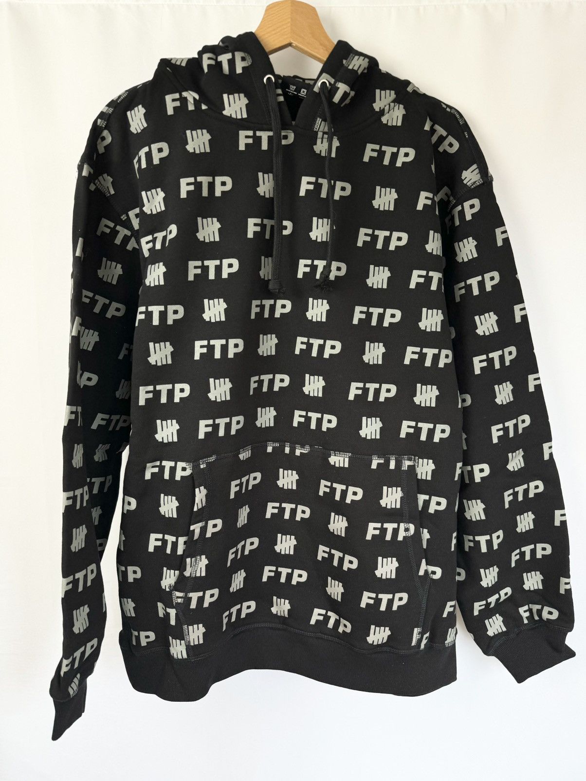 image of Fuck The Population x Undefeated Ftp X Undefeated All Over Logo Hoodie in Black, Men's (Size Large)