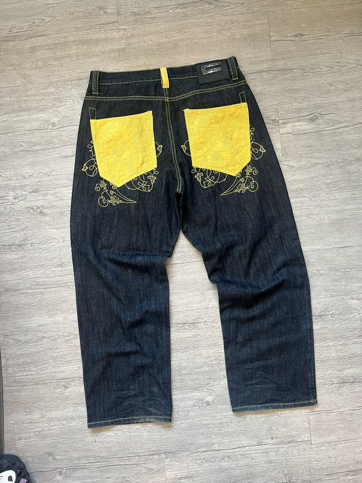 Coogi denim yellow back pocket