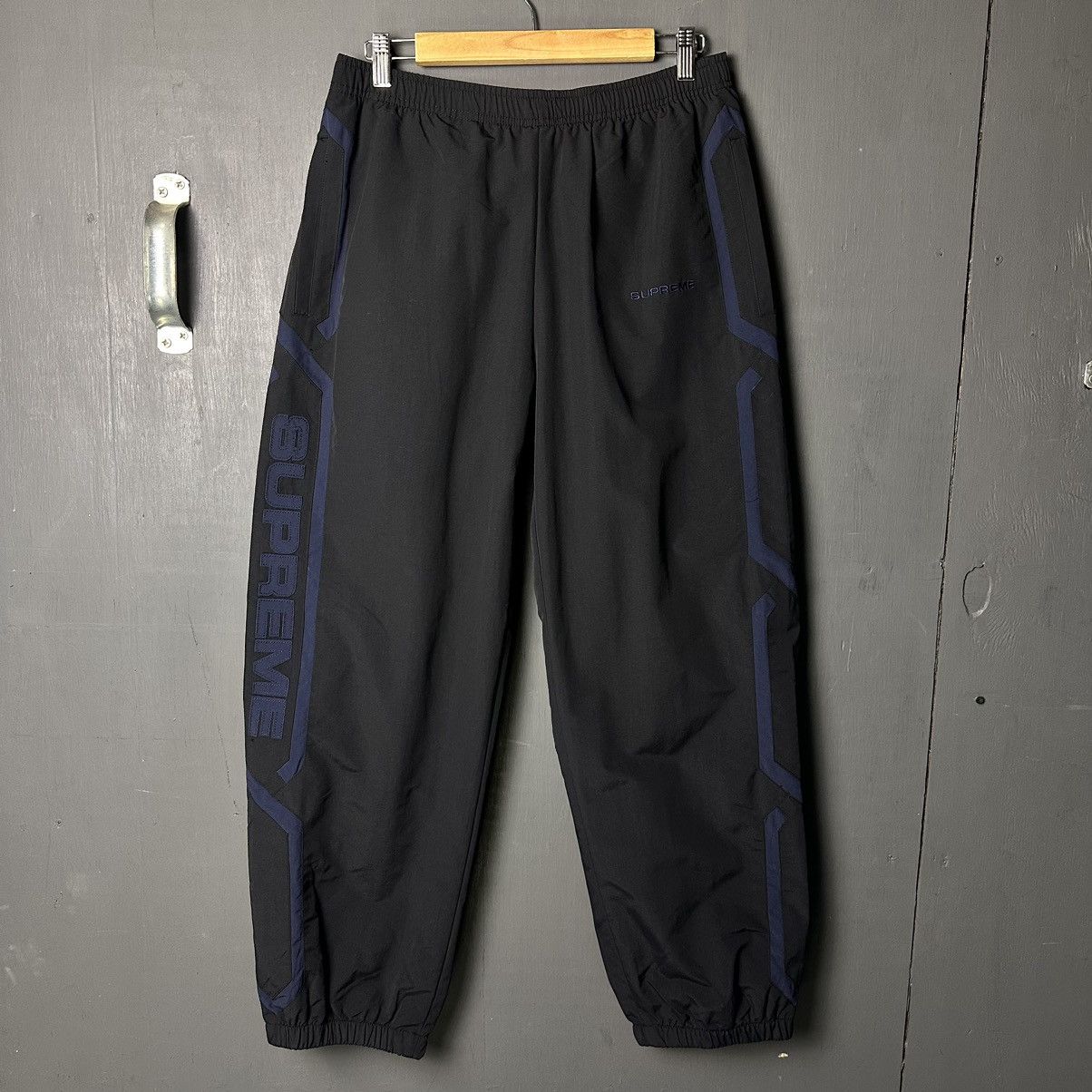 image of Supreme Inset Logo Track Pants (Black) in Black/Navy, Men's (Size 30)