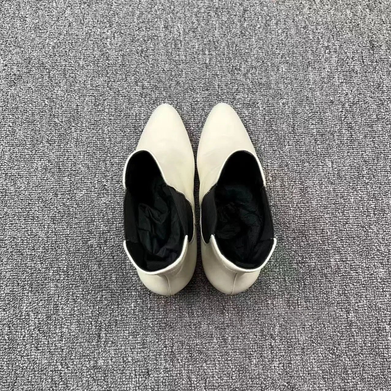 white leather pointed toe chelsea boots.