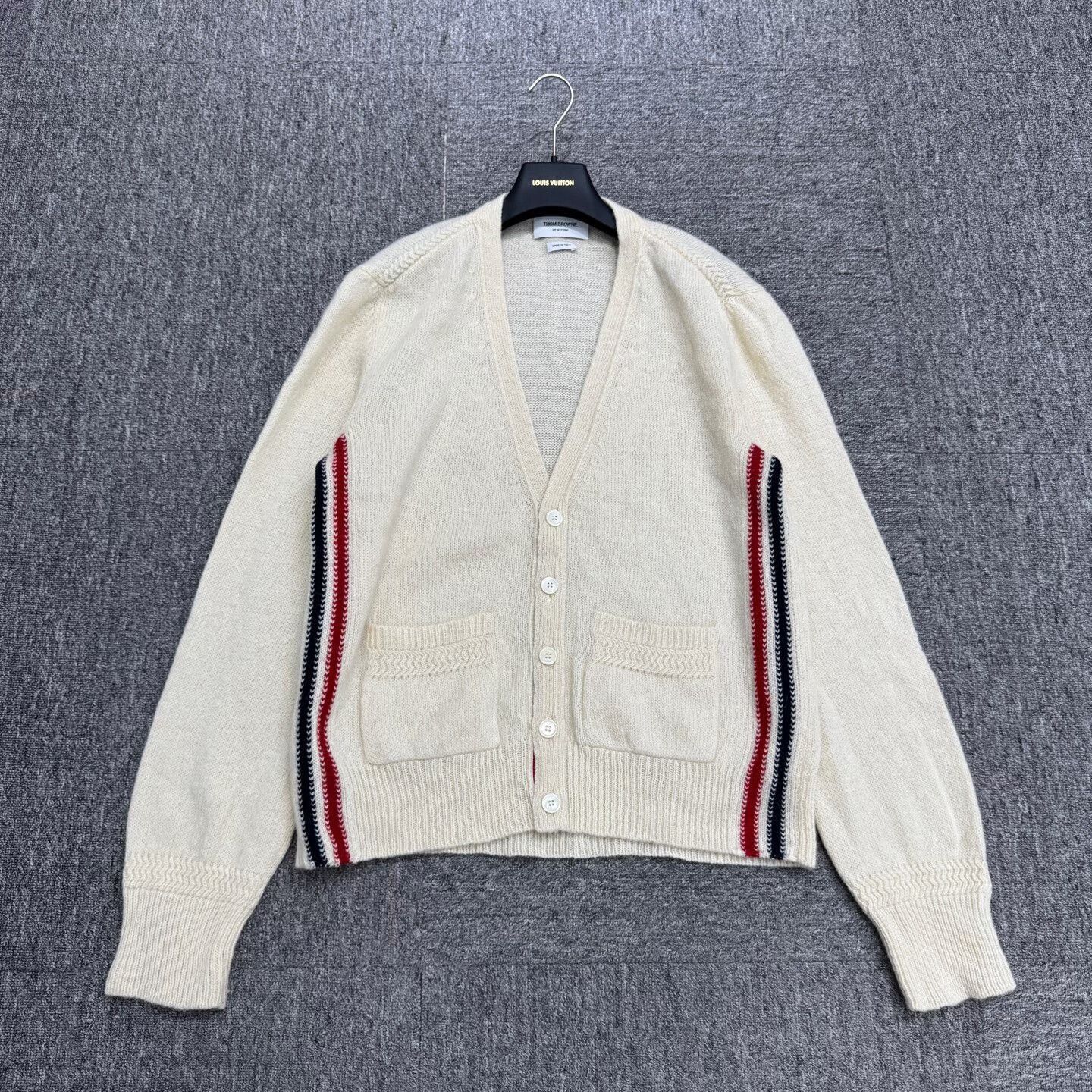 beige wool cardigan from Thom Browne.