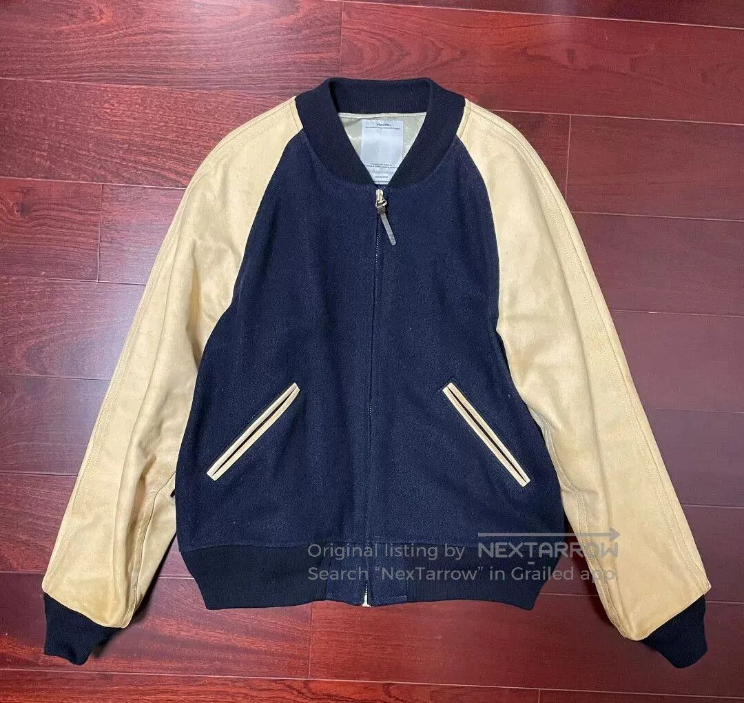 visvim baseball jacket with natural leather sleeves.