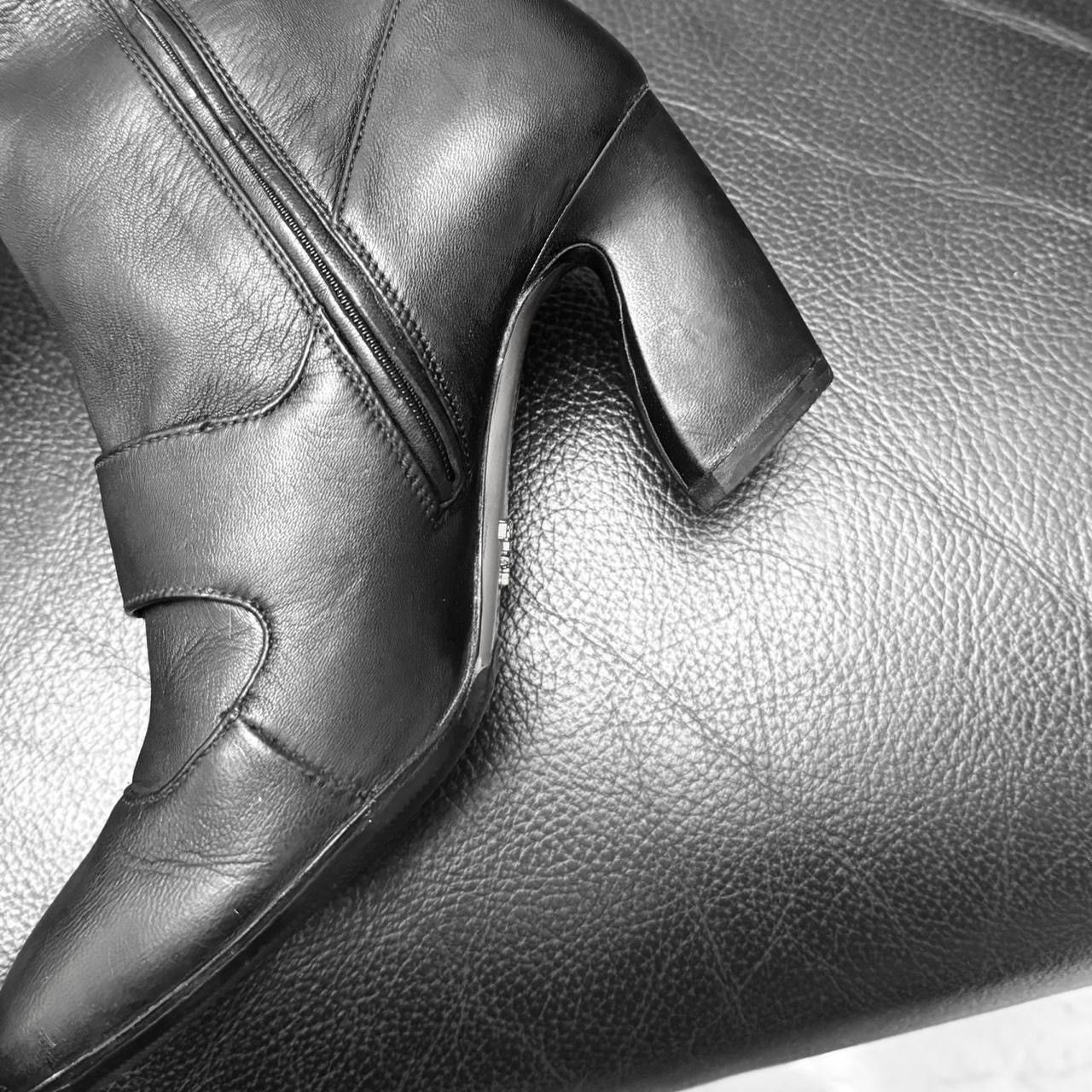 Prada archive leather boots asymmetric heel button detail.
