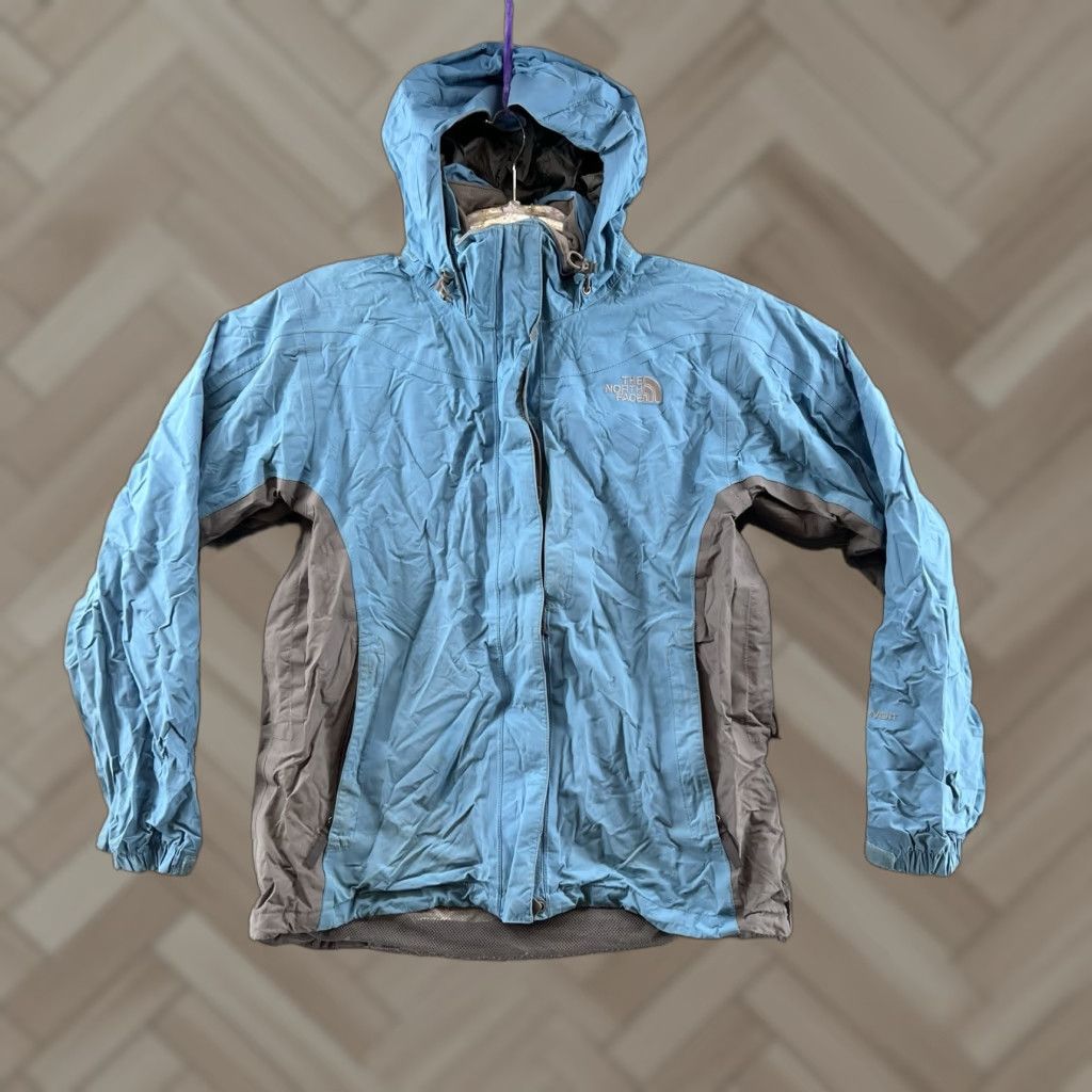 The North Face Women’s M packable hooded full zip light blue rain Jacket