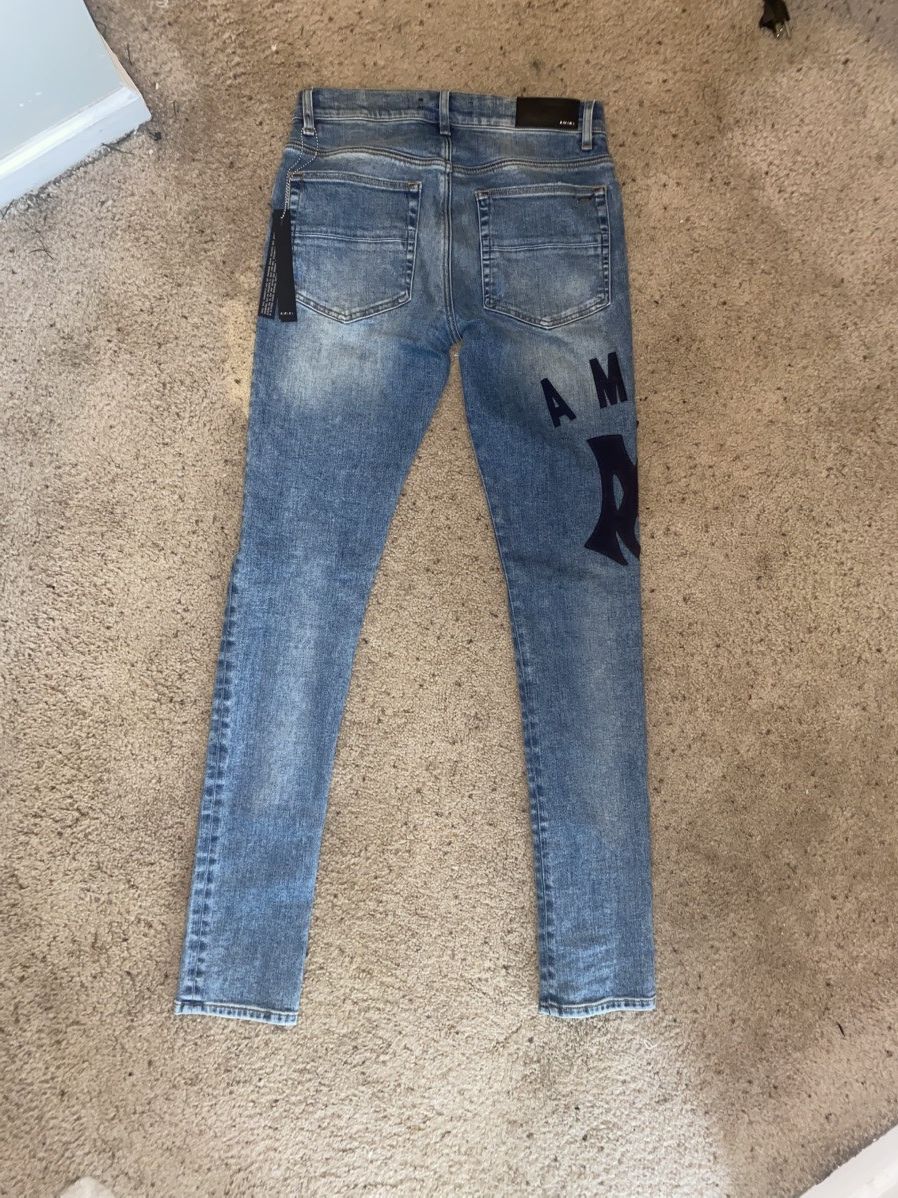 Amiri suede appliqué logo jeans