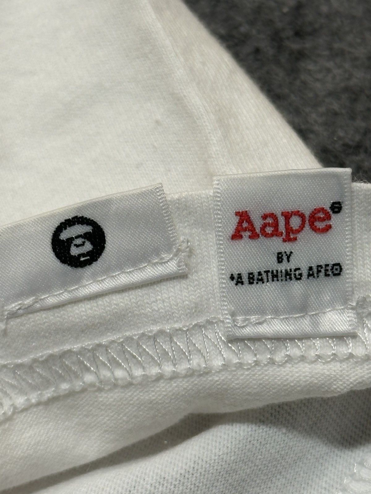 Aape AAPE by A Bathing Ape Moon Face Camo T-shirt in white. Size US M / EU 48-50 / 2 - 9 Thumbnail