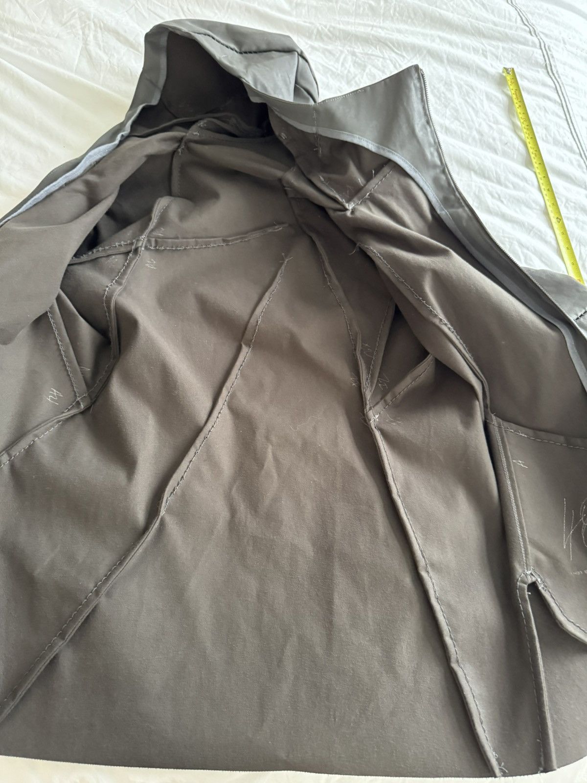 Unlined hand stitched hooded jacket.